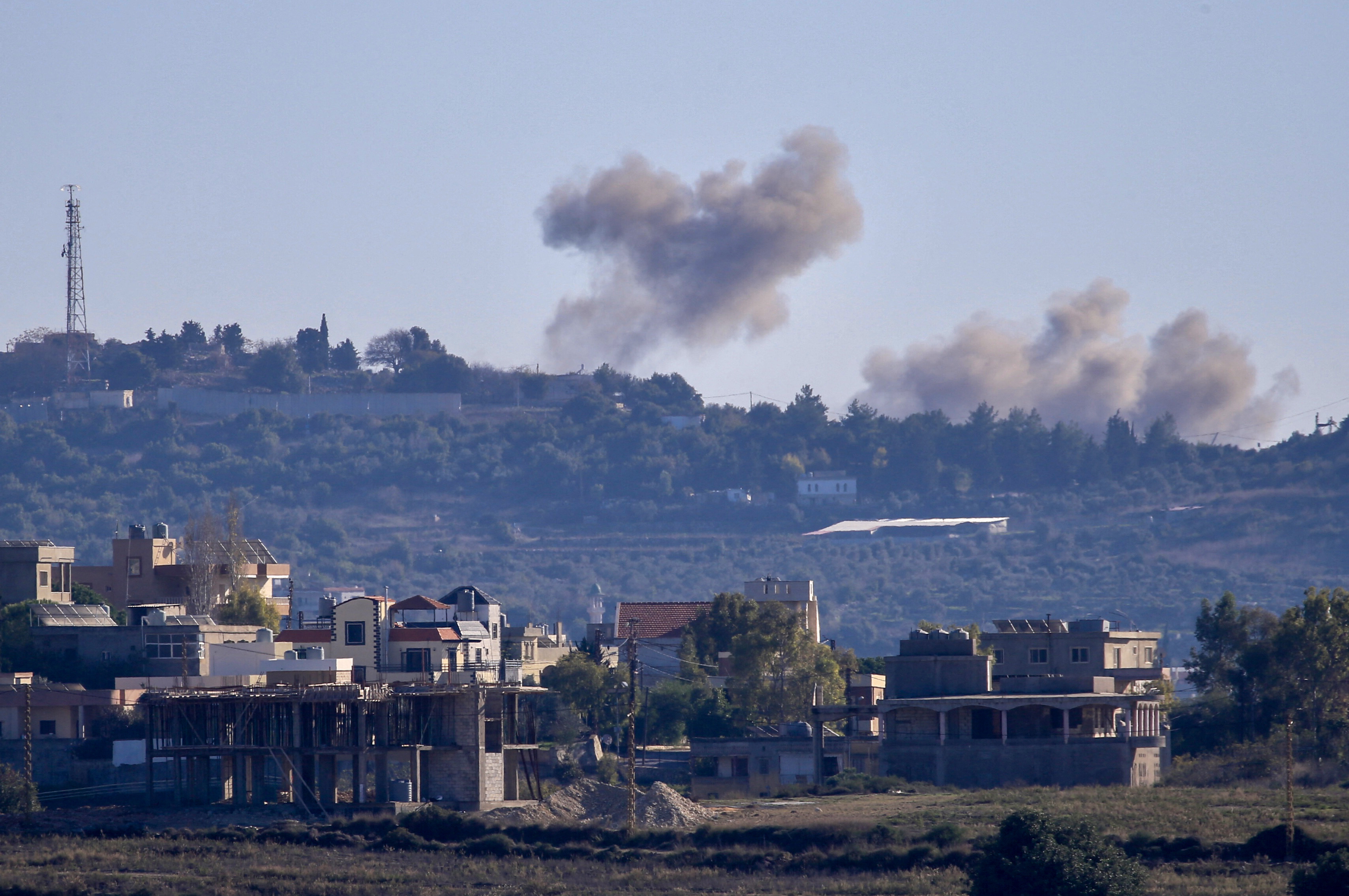 A picture taken from from the southern Lebanese village of Tayr Harfa, near the border with Israel, shows smoke billowing near an Israeli outpost from rockets fired by Hezbollah on Dec. 15. (AFP via Getty Images)