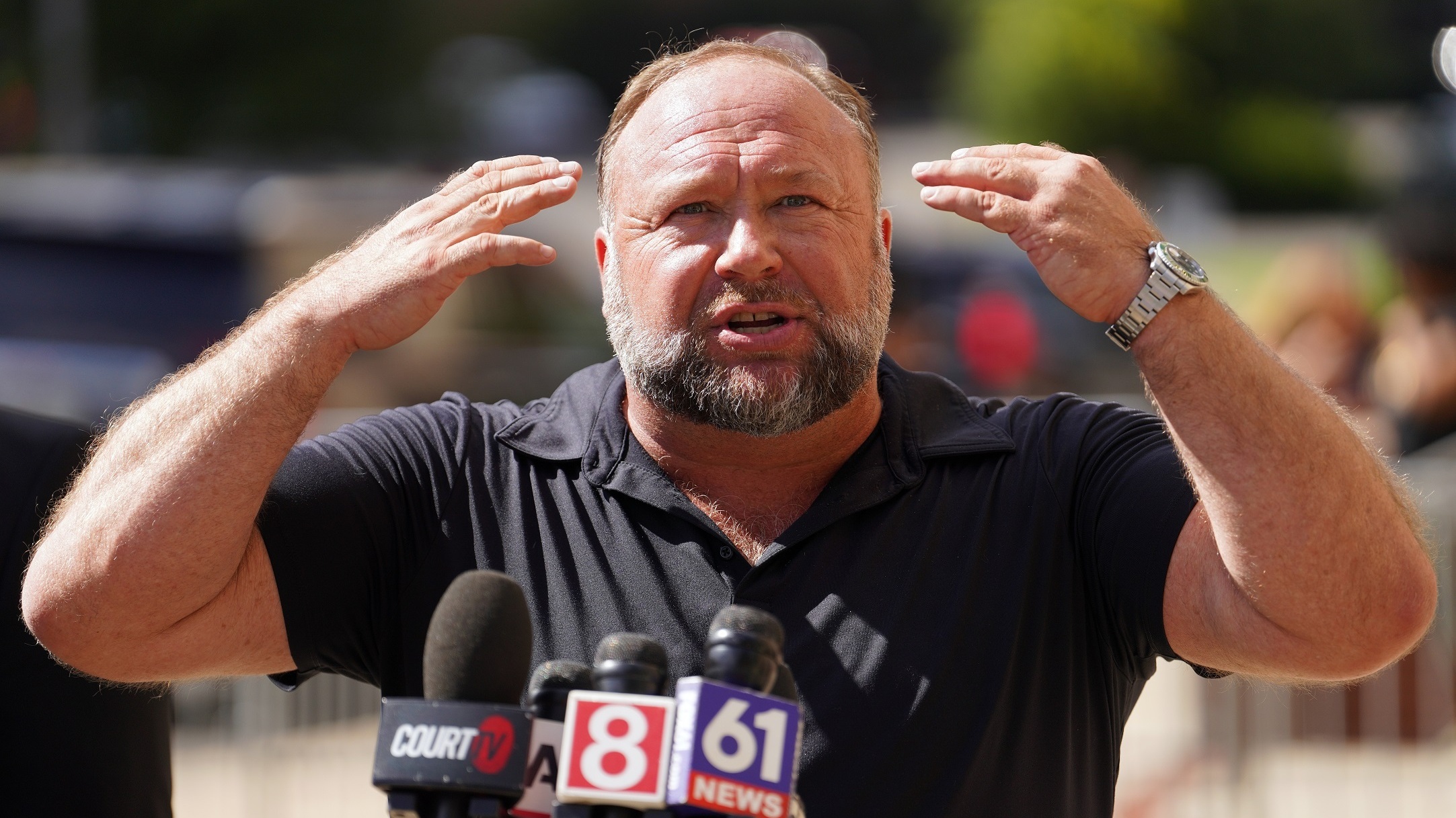 InfoWars founder Alex Jones speaks to the media outside Waterbury Superior Court during his trial on Sept. 21, 2022 in Waterbury, Conn.