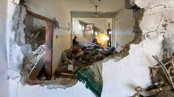 A home in Rafah with a hole in its wall in the aftermath of an Israeli airstrike.