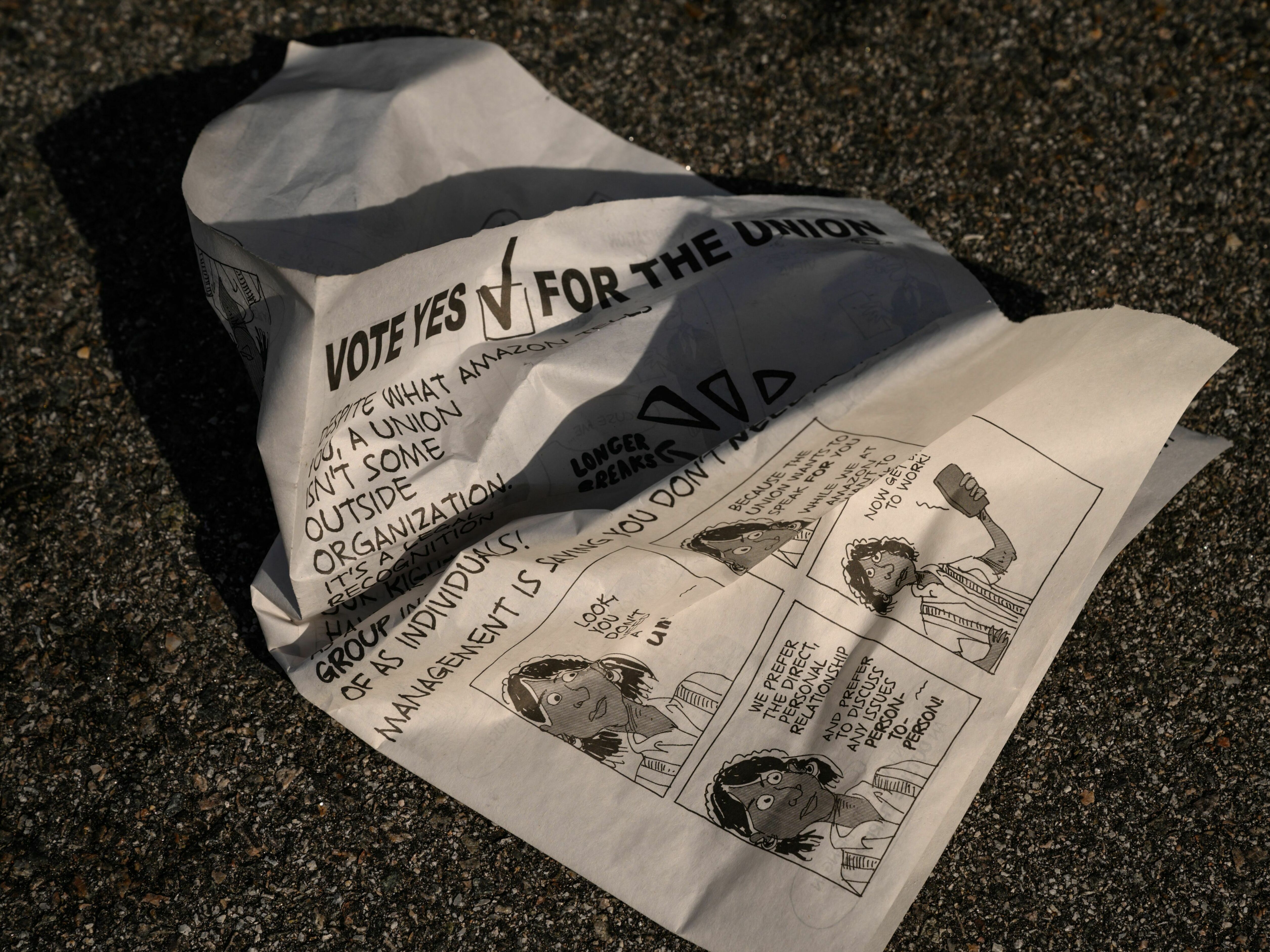 A leaflet is discarded as workers make their way to cast their vote over whether or not to unionize an Amazon warehouse on Staten Island on March 25, 2022. The union won the election but has still not been recognized by Amazon. (AFP via Getty Images)