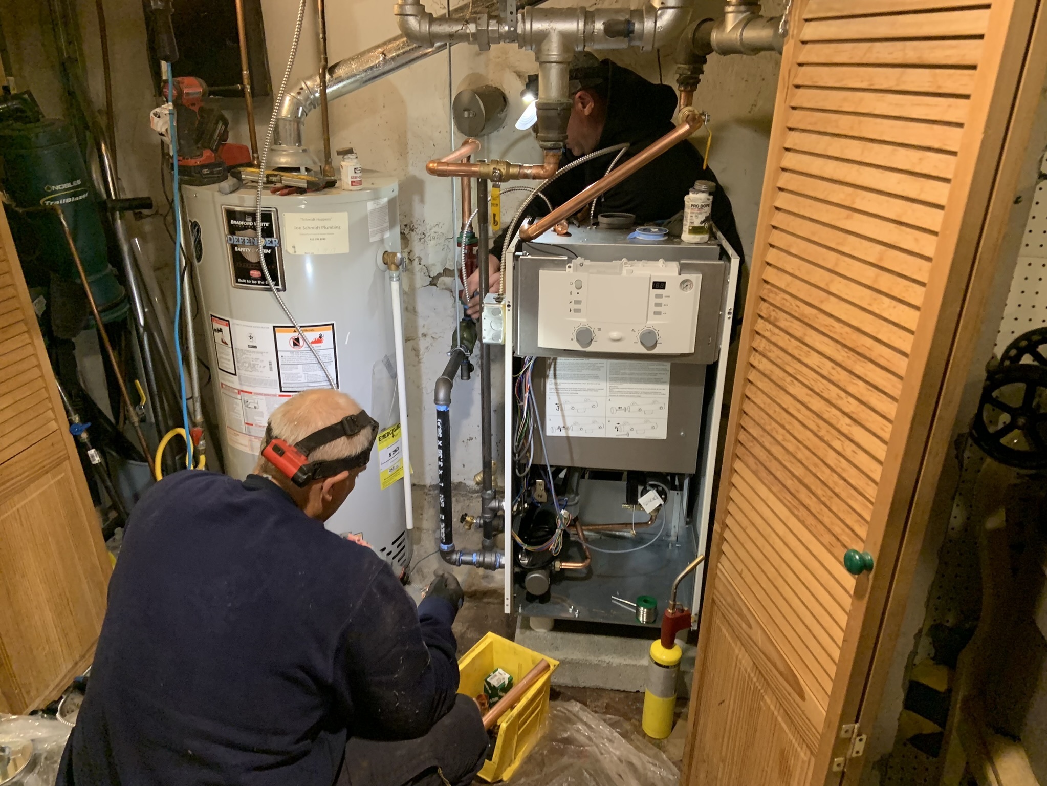 Oval Heating and A/C workers install a more efficient condensing gas boiler in a Sharon Hill, Pennsylvania home. New Department of Energy efficiency standards can only be met with these boilers or furnaces, which save customers about 15% on their gas utility bill. (NPR)