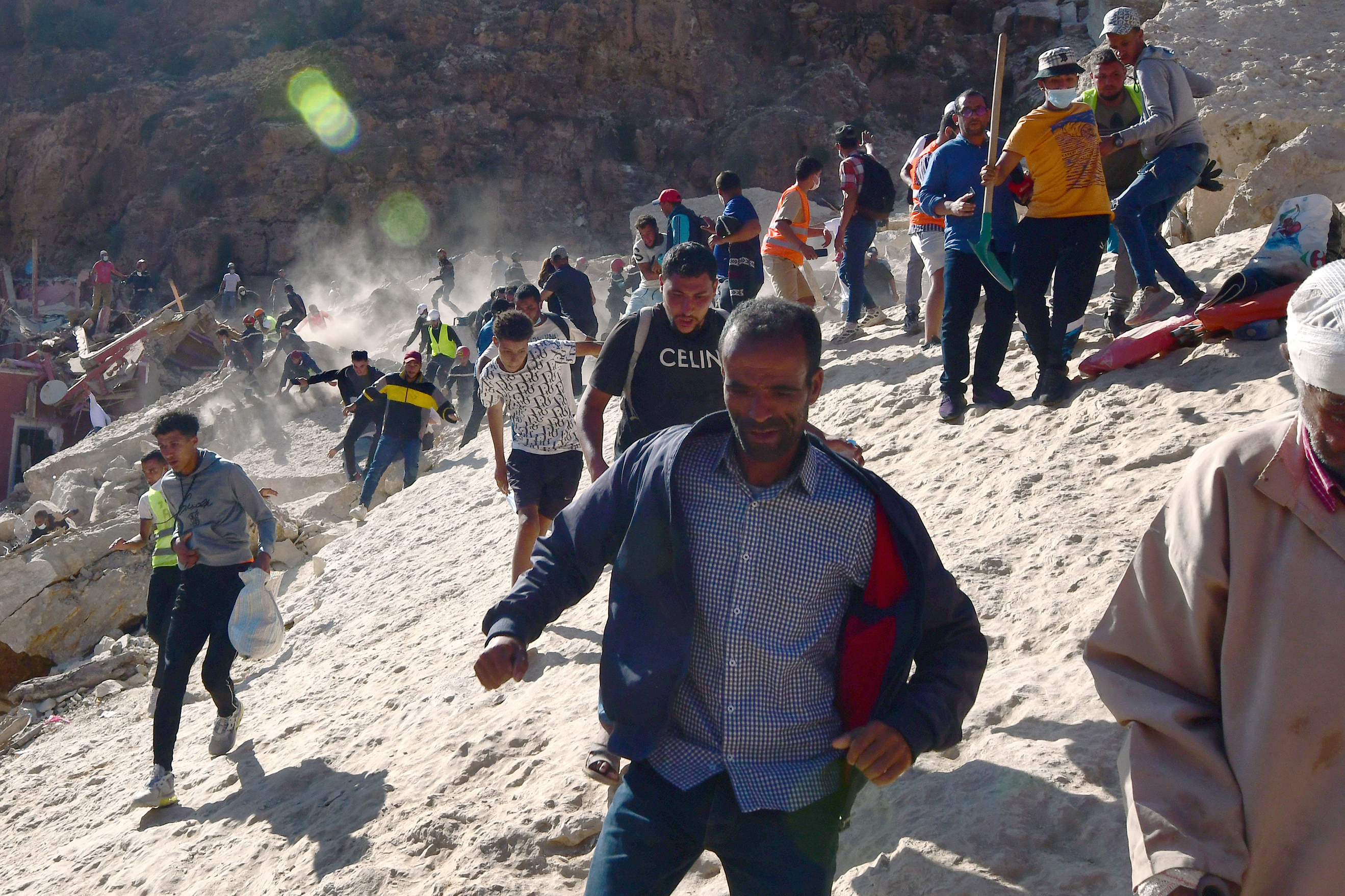 IMI N'TALA, MOROCCO — Civil protection and rescue workers who had been digging out a body from the rubble of a devastating earthquake run in panic during an aftershock in Morocco on Sept. 13. There is danger of more rock falling from the mountain that destroyed the town. Click here for the full story.