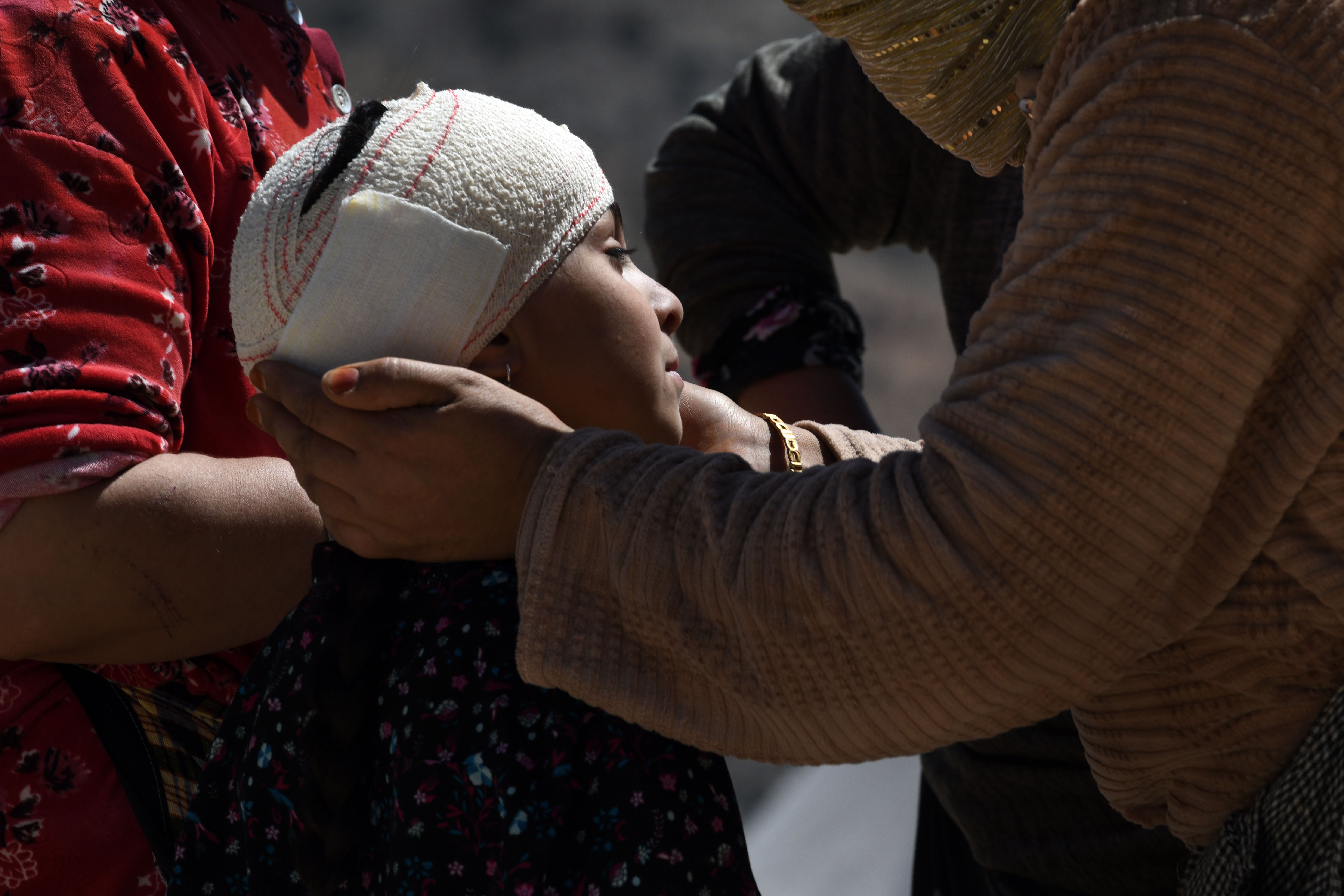 IMI N'TALA, MOROCCO — Walking wounded residents wait as rescue teams and civil protection members search the rubble for bodies of victims that perished in the devastating earthquake in Morocco on September 13, 2023. Click here for the full story.