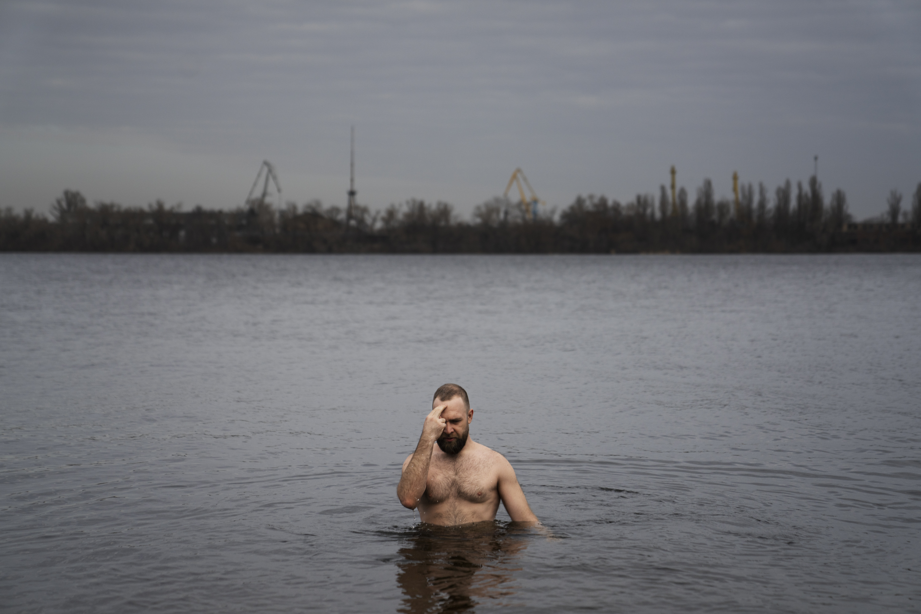 DNIPRO, UKRAINE — Nikolai Pastuchenko crosses himself as he dips in the river on in Dnipro. Pastushenko is one of about three dozen people who have come down to this spot along the Dnipro River to take the plunge, a tradition across Ukraine — and Russia. Click here for the full story.
