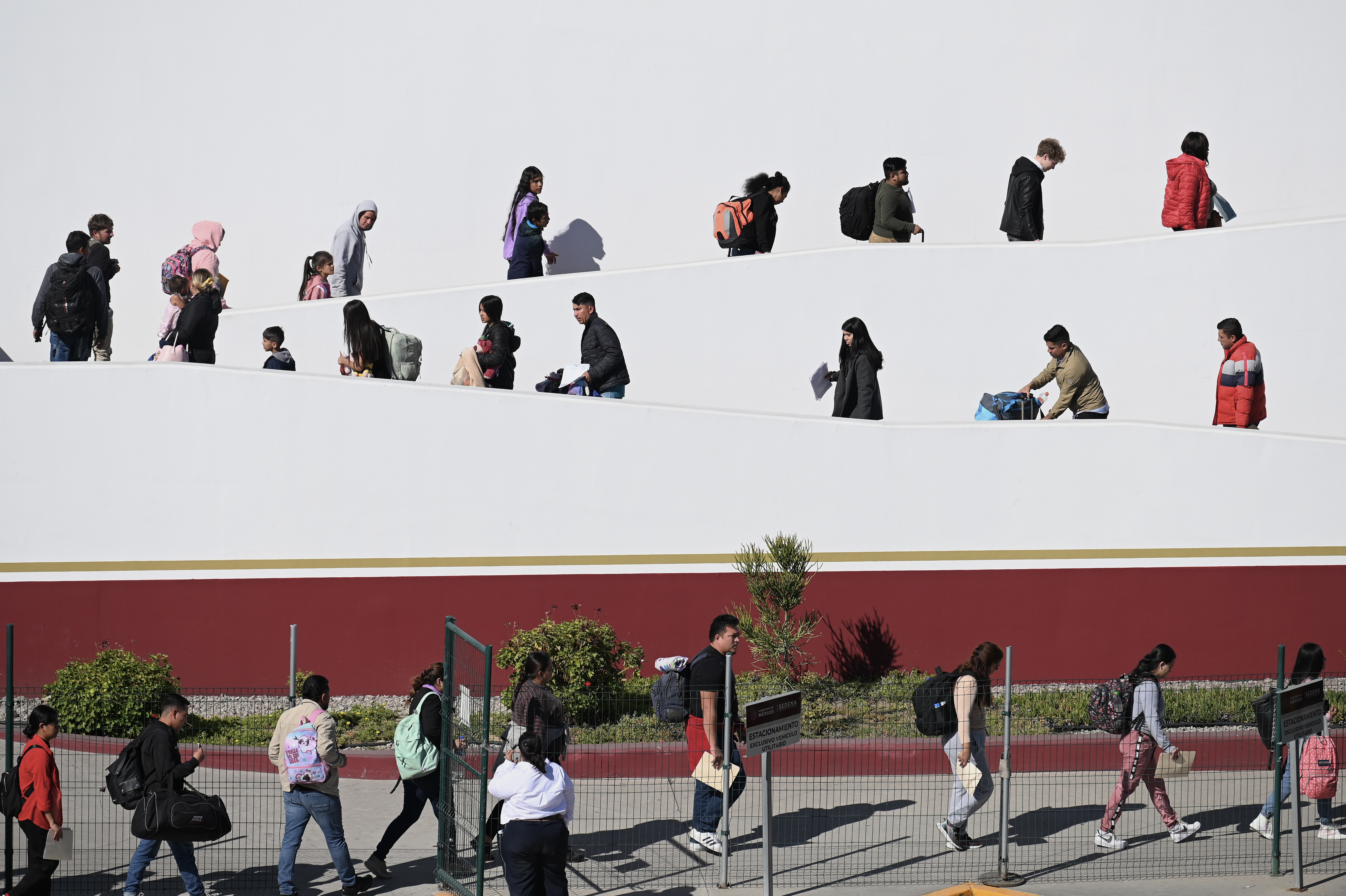 TIJUANA, MEXICO — Migrants with CBP One asylum appointments at the Chaparral pedestrian border in Tijuana, Mexico cross into the US. Click here for the full story.