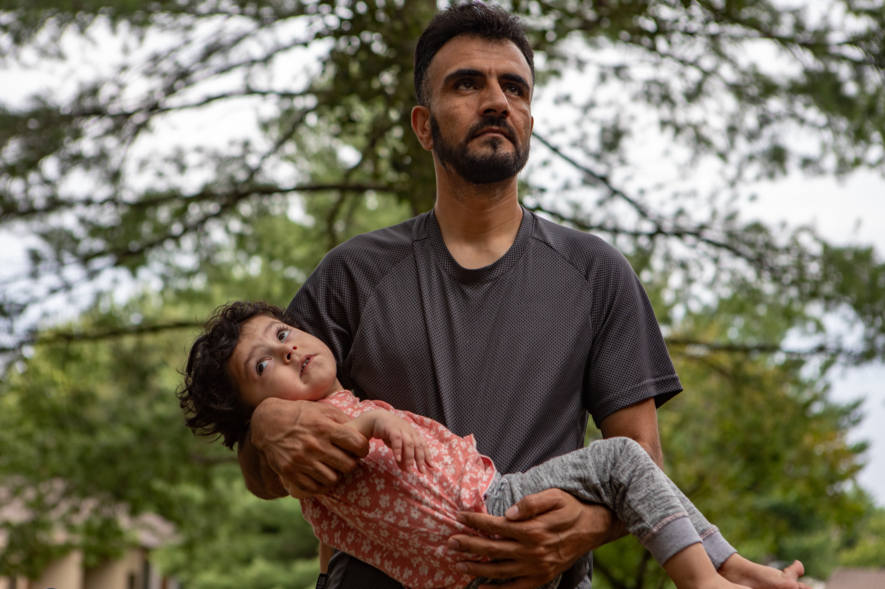 ALEXANDRIA, VA,: Shafi Amani holds his 3-year-old daughter Yousra outside the Casey Clinic in Alexandria, Va., where they go every couple of weeks for care. Amani and his family fled Afghanistan. See the story.