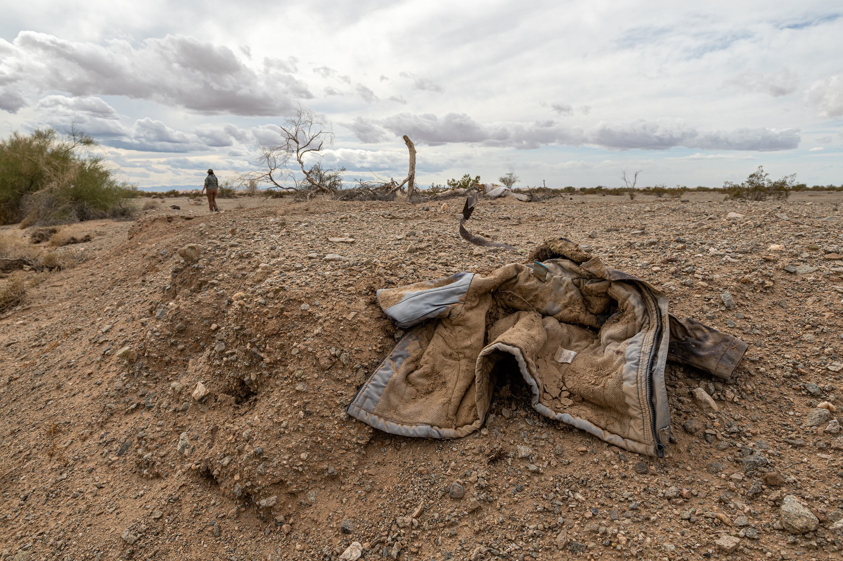 YUMA, Ariz.: Jacqueline Arellano hikes through a wash she suspects migrants move though on their way north after crossing the border. She volunteers with a group that is extending its services to desert areas to assist lost or hurt migrants. See the story.