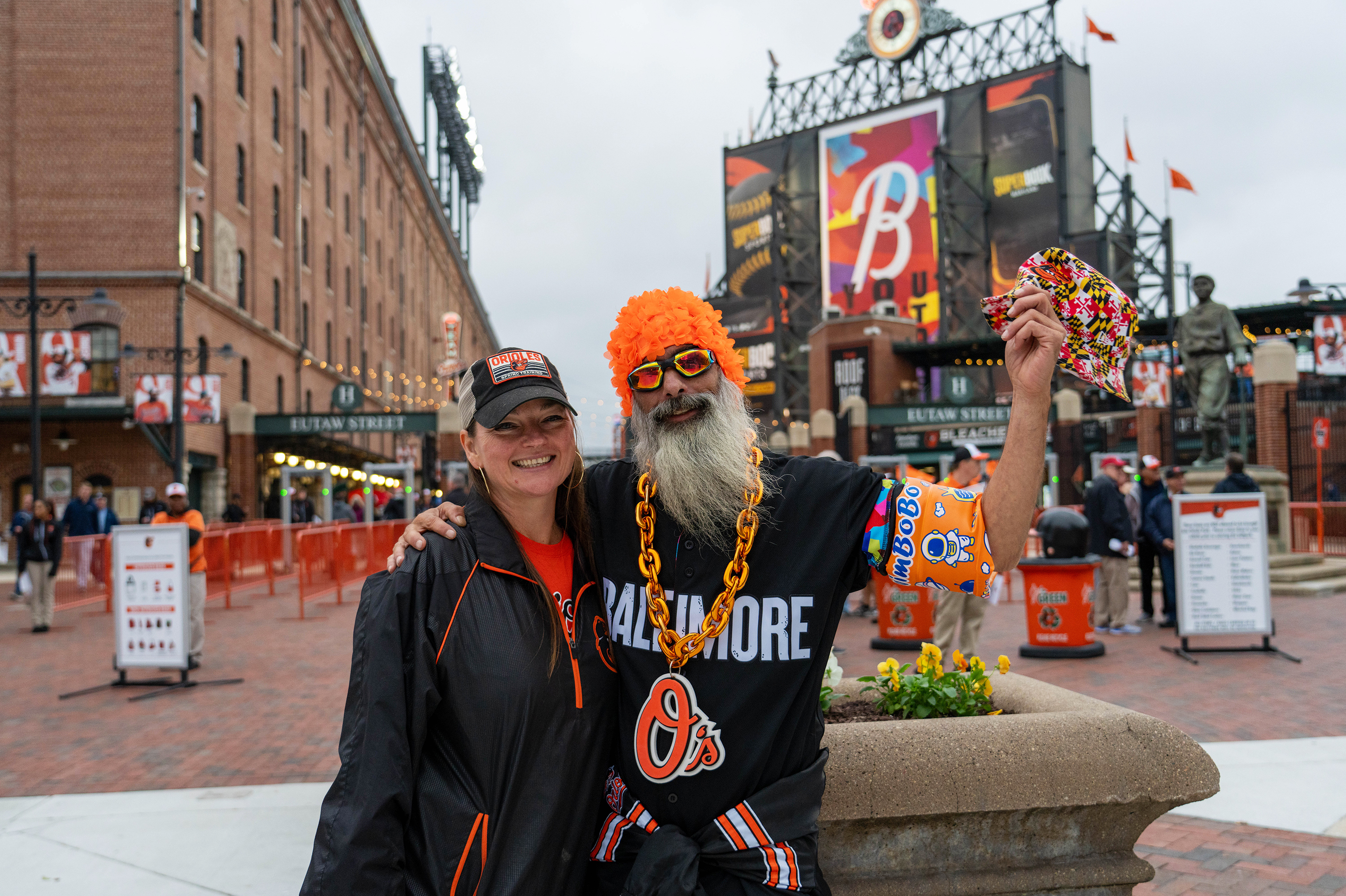 BALTIMORE, MD.: Claire Sanford and Chad Richhart have been coming to see the Baltimore Orioles since 1992. They came dressed for the bird bath, a splash zone seating area for fans at Camden Yards. See the story.