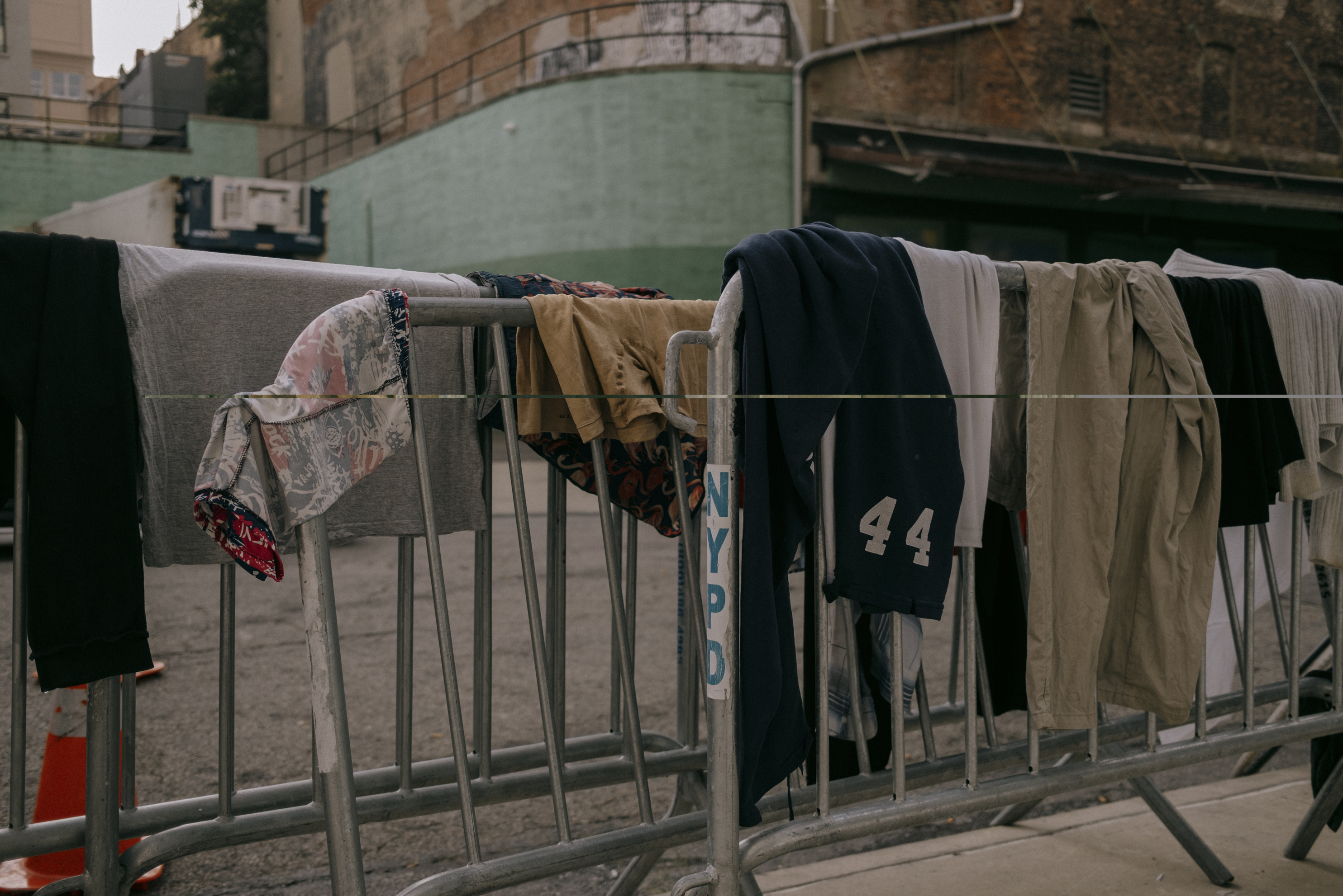 NEW YORK CITY: As asylum seekers spill out onto Hall Street outside of the Clinton Hill Shelter, clothing hangs to dry after being washed inside the facility's two shower units on Wednesday, July 19, 2023. See the story.
