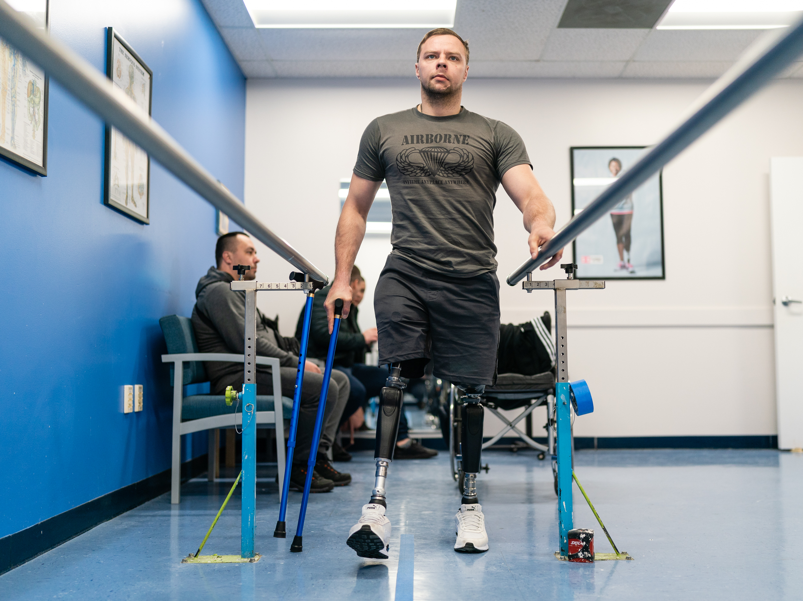SILVER SPRING, MD: Oleksandr Fedun, 24, holds onto railings as he practices walking on his prosthetics at Medical Center Orthotics & Prosthetics in Silver Spring, Maryland on February 2, 2023. See the story.
