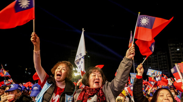 Taiwanese residents wave flags.
