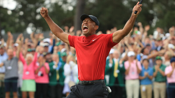 iger Woods celebrates on the 18th green after winning the Masters at Augusta National Golf Club on April 14, 2019 in Augusta, Ga.