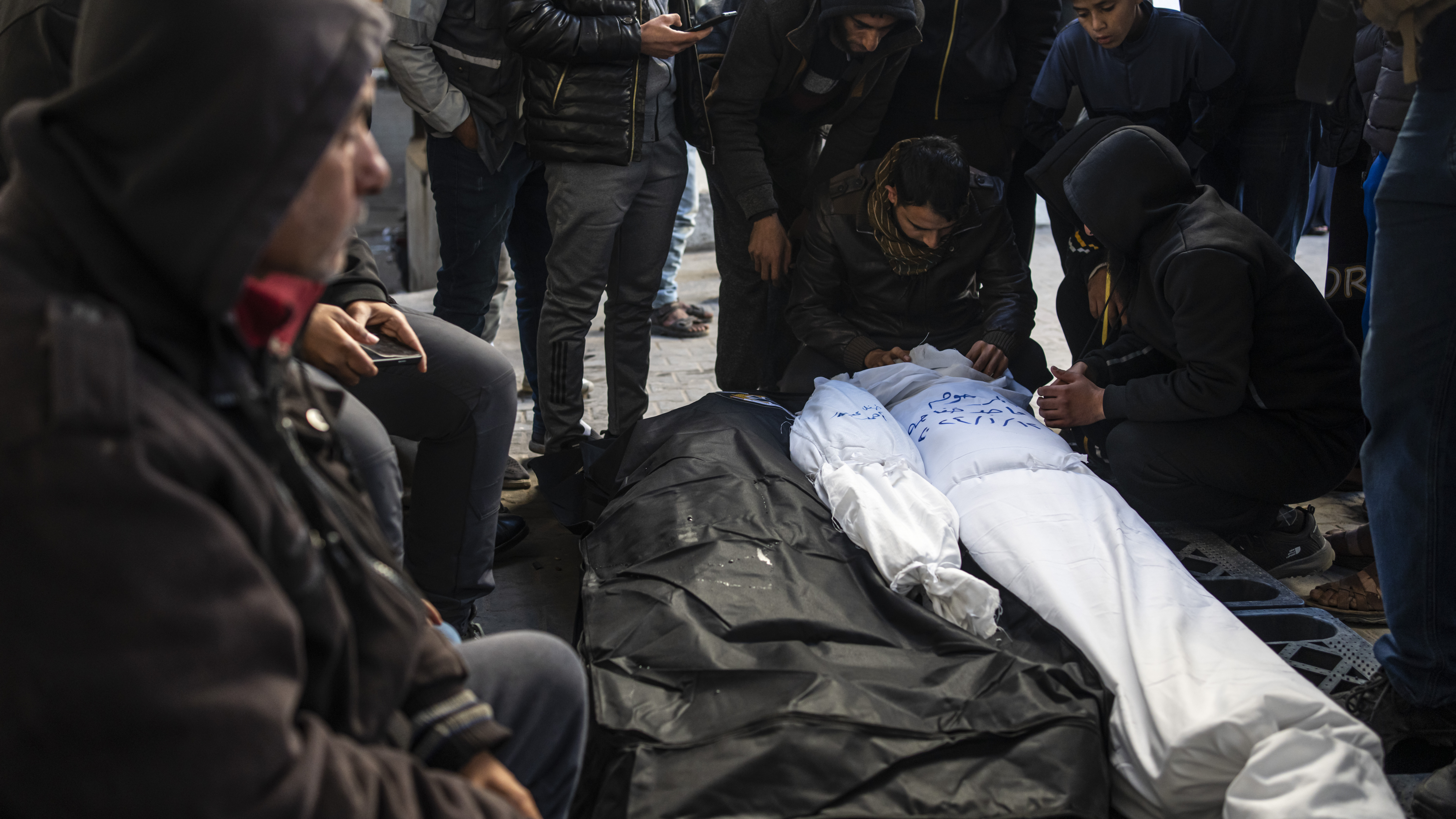 Palestinians mourn relatives killed in the Israeli bombardment of the Gaza Strip in Rafah, Saturday, Jan. 13, 2024.