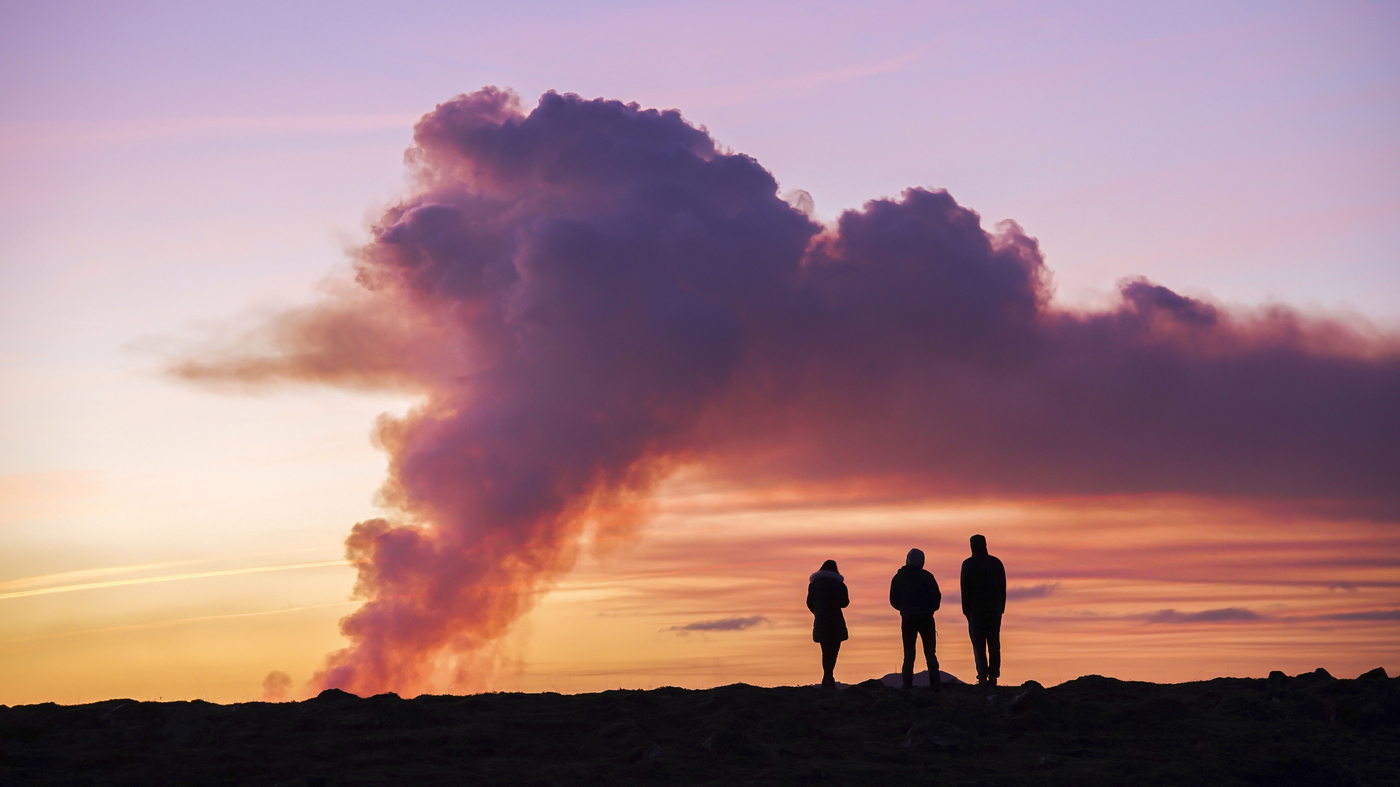 A volcano erupts in Iceland, sending lava flowing toward a nearby town