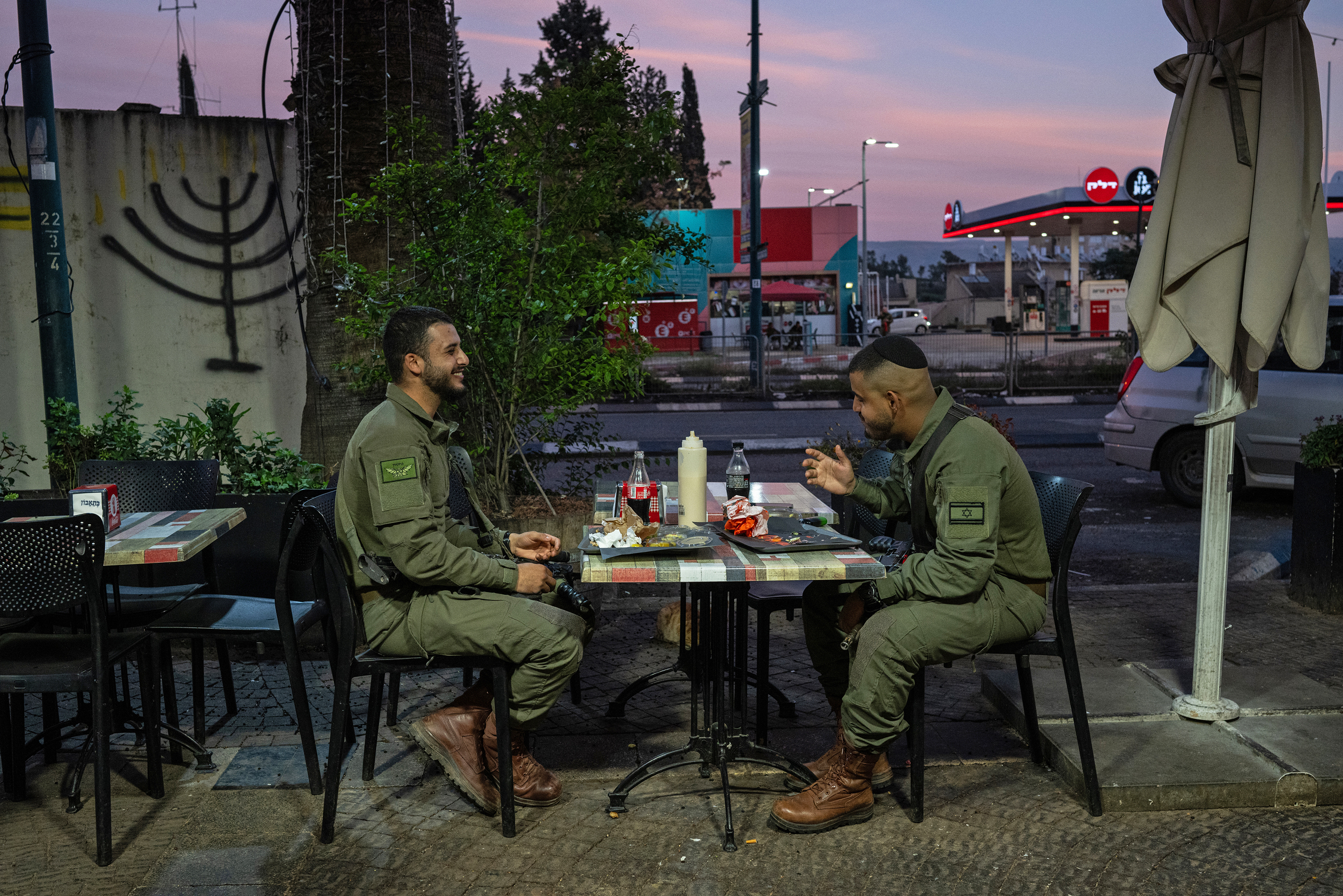 Soldiers eat dinner at a restaurant in Kiryat Shmona, Israel, on Jan. 7. Kiryat Shmona, located approximately a mile from the border with Lebanon, was evacuated as hostilities with Hezbollah escalated following the Oct. 7 attacks.