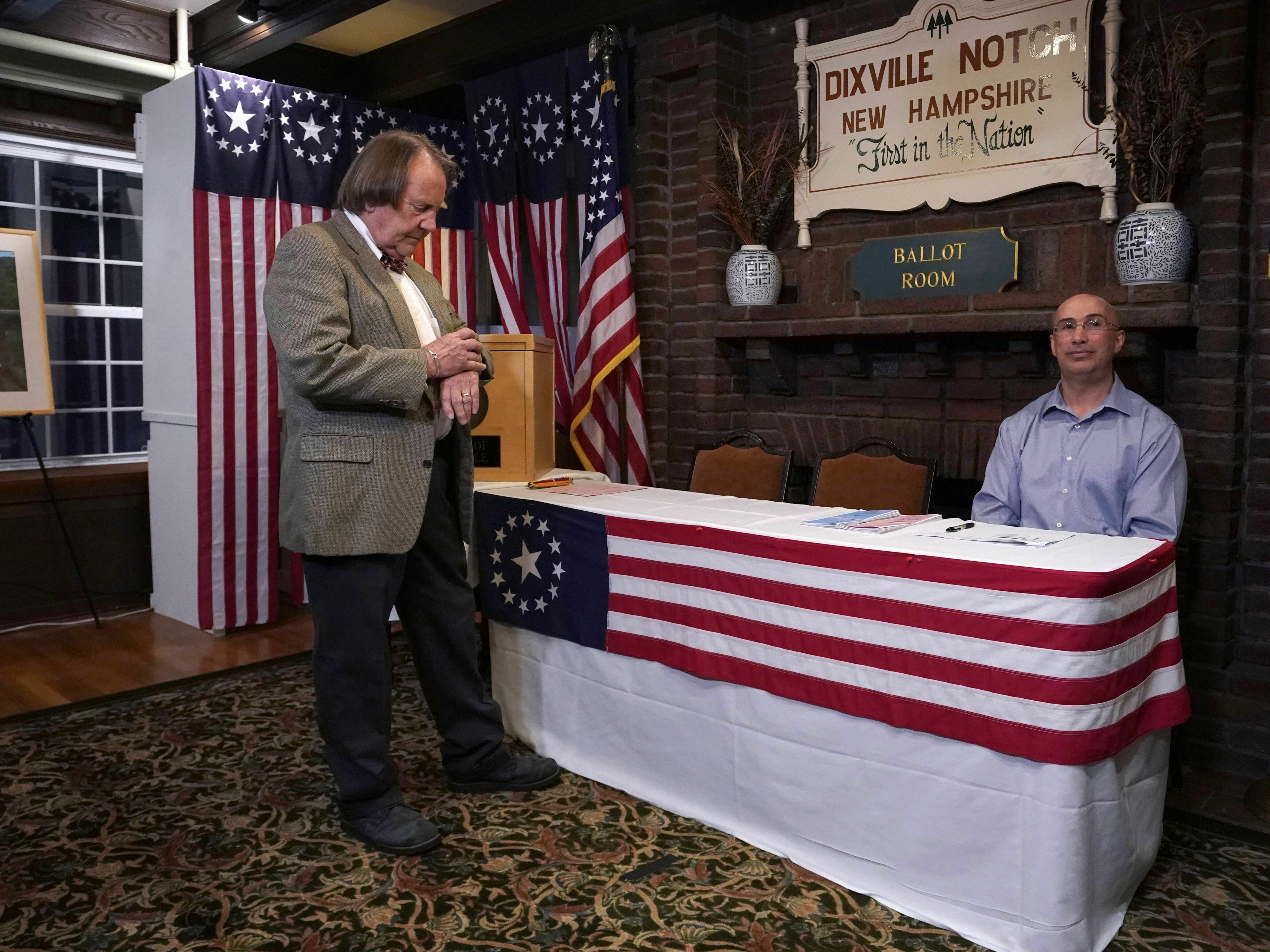 Dixville Notch Town moderator Tom Tillotson checks his watch just before midnight voting at the Hale House at the Balsams Resort in 2020.