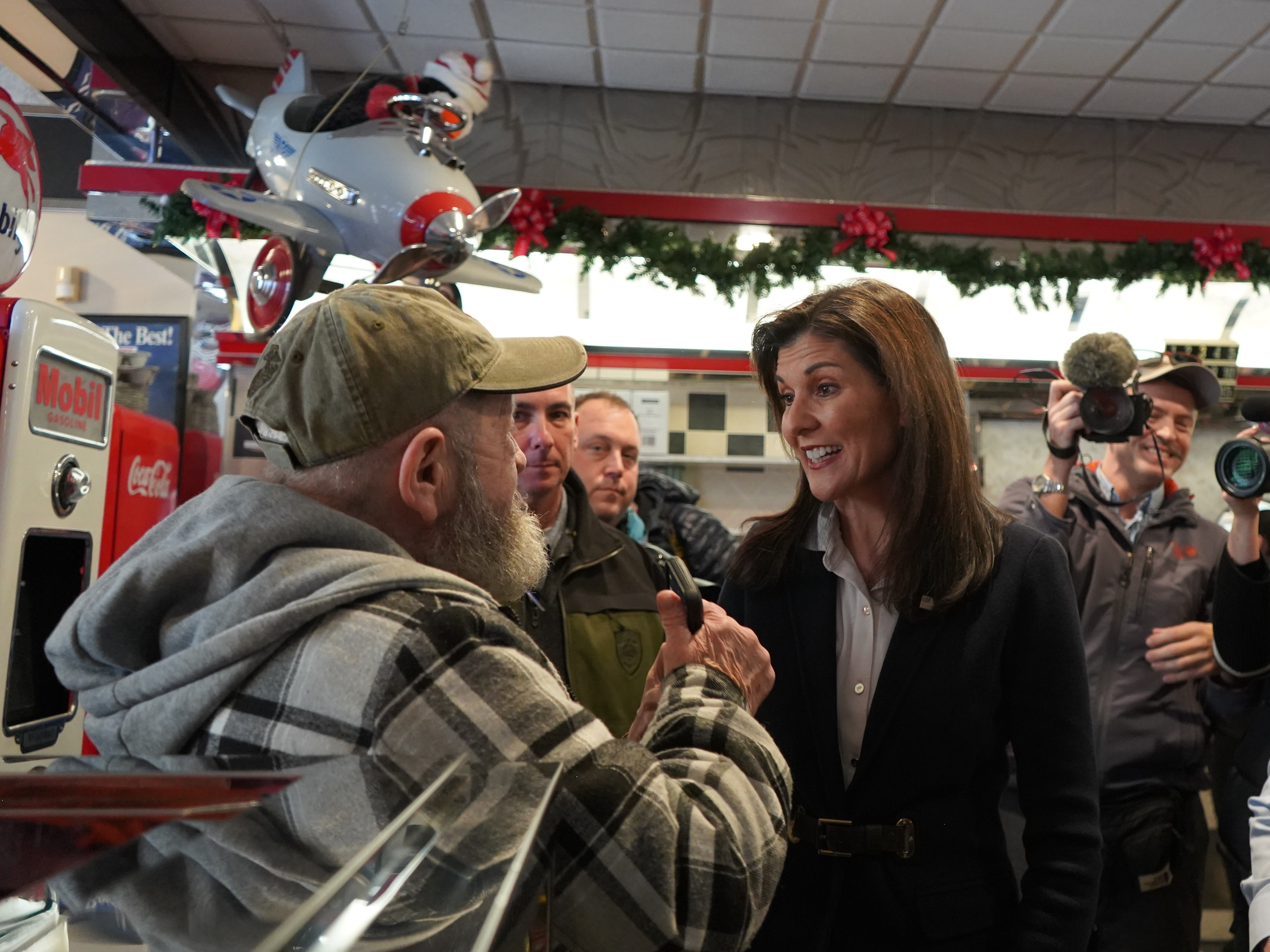 Republican presidential candidate and former UN Ambassador Nikki Haley speaks to a voter at a diner in Milford, N.H., on Jan. 19.