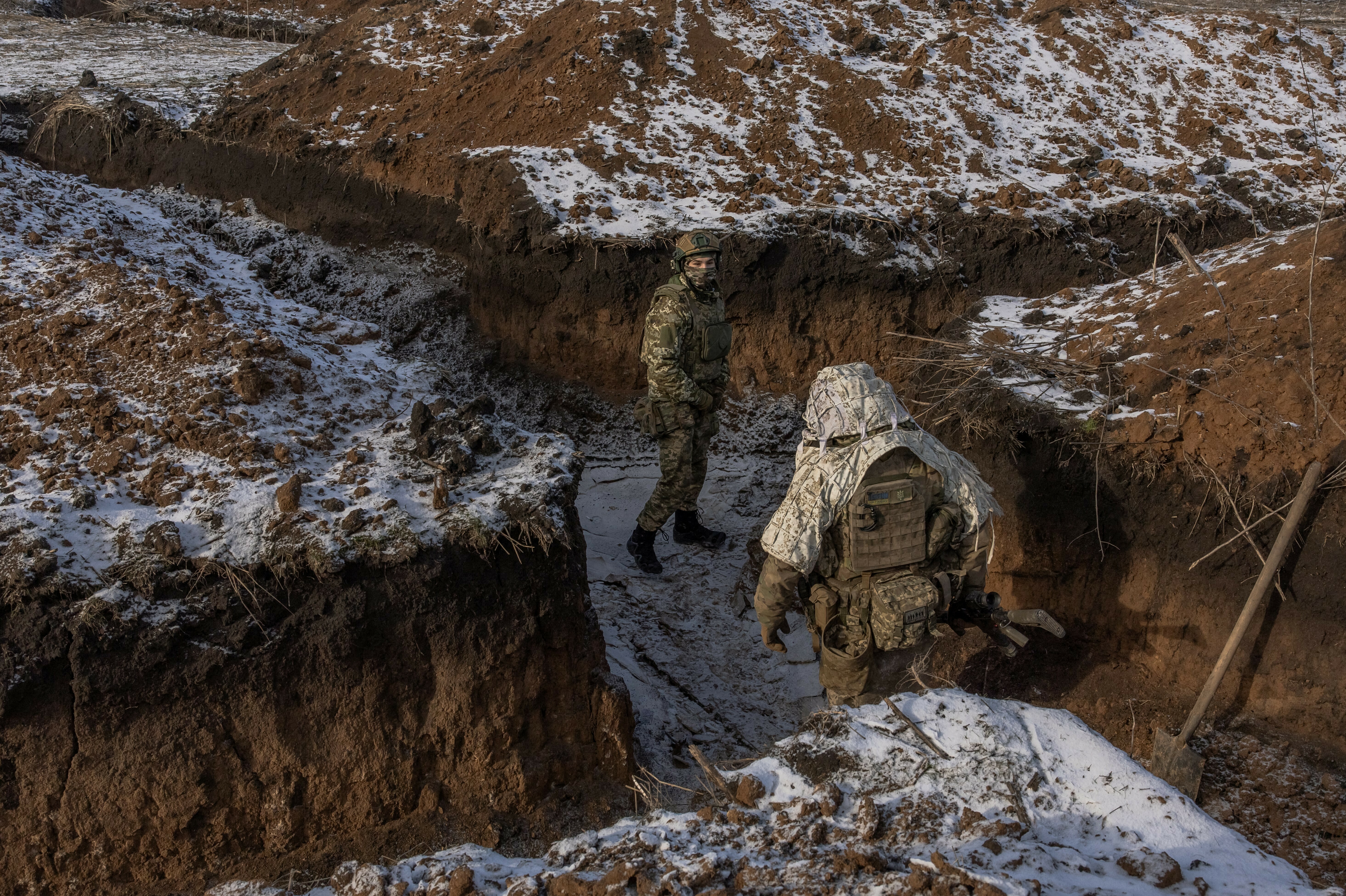 As Ukraine seeks to replenish its depleted army, a divide grows among its civilians 2 Ukrainian soldiers of the 41st Brigade walk in a trench near the front line outside Kupiansk, in Ukraine's Kharkiv region, on Jan. 23.
