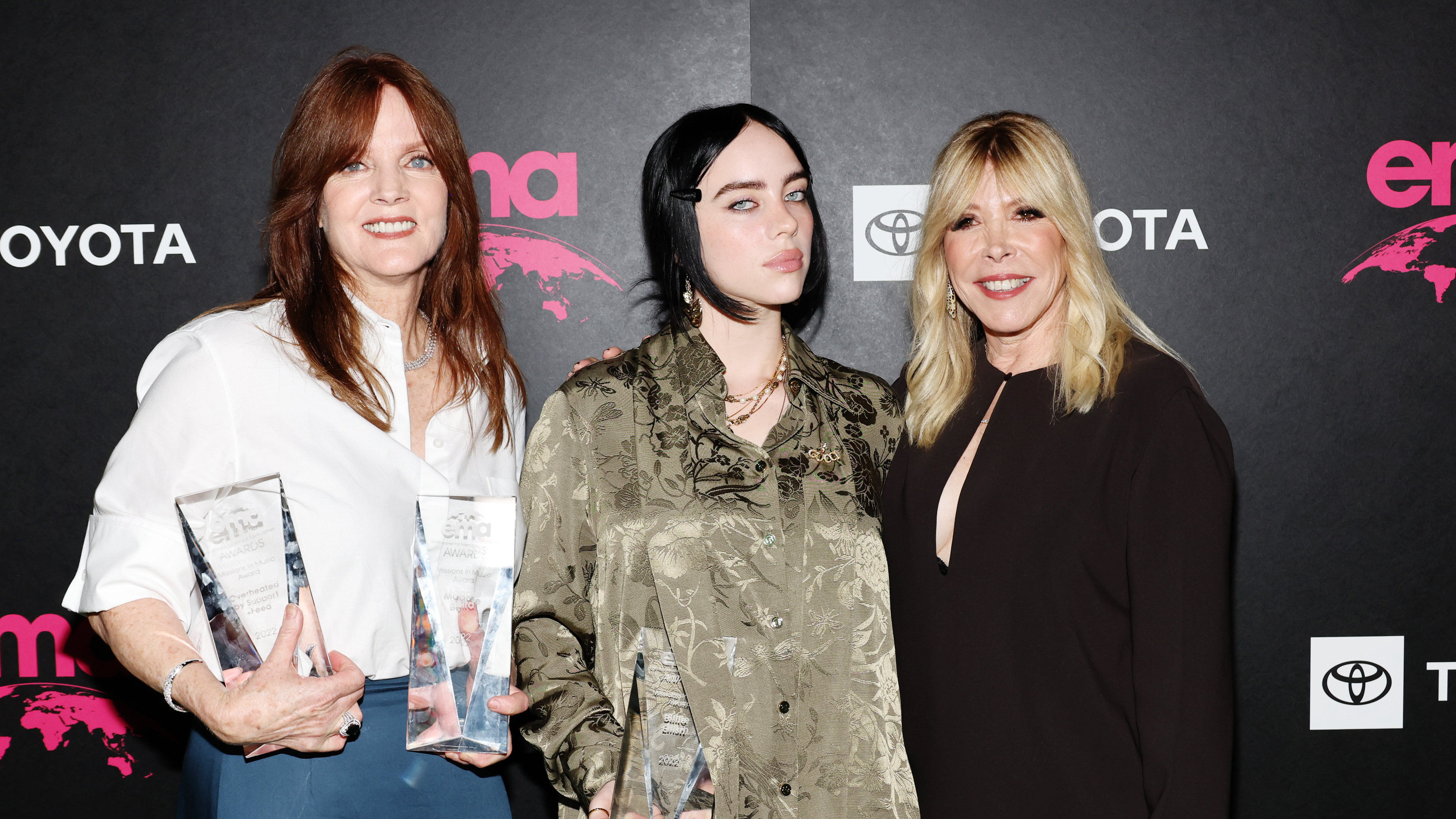 Billie Eilish at the 32nd Environmental Media Association (EMA) Awards Gala in Los Angeles, Oct. 8 2022. The pop star is flanked by her mother Maggie Baird (left) and EMA CEO Debbie Levin.