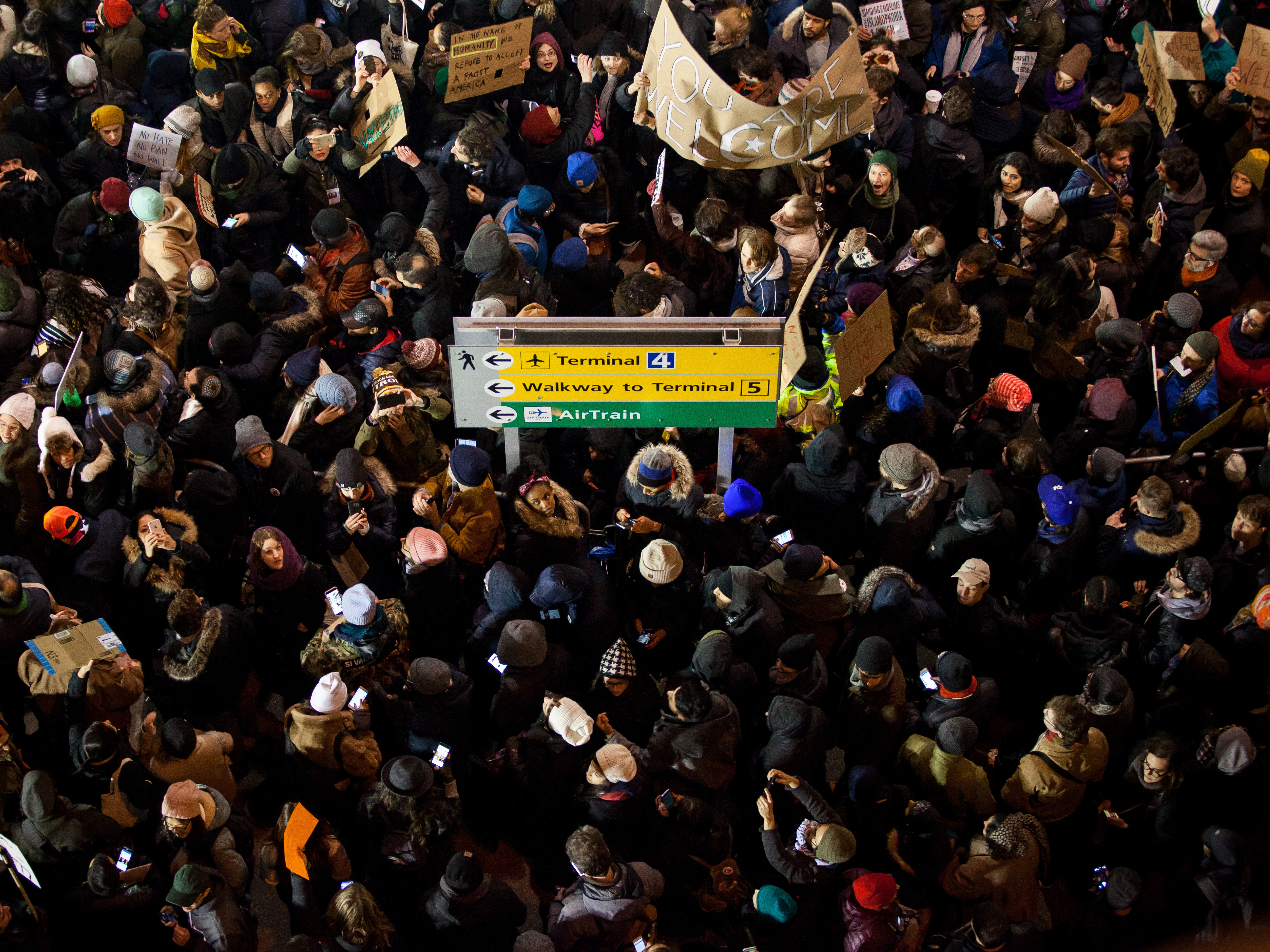 Demonstrators gather outside of John F. Kennedy International Airport airport in New York to protest shortly after former President Donald Trump's executive order blocking visitors from seven predominantly Muslim nations went into effect in January 2017. Trump is promising to implement even more extreme immigration policies if he wins another term in November. (Bloomberg via Getty Images)