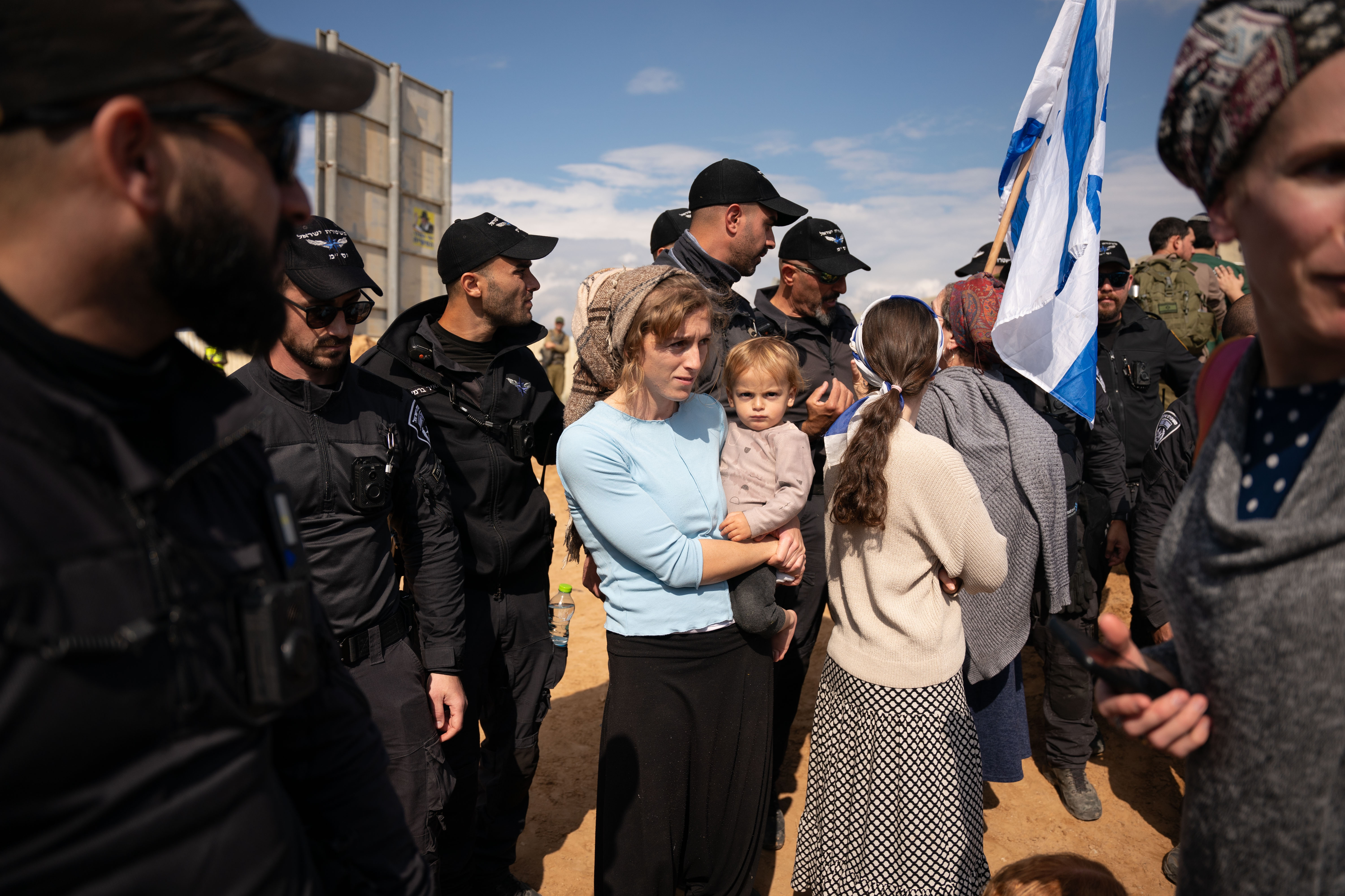 Israeli border police watch over protesters attempting to block the road at the Kerem Shalom border crossing, where Israel inspects trucks and allows them to cross into the Gaza Strip. (Maya Levin for NPR)