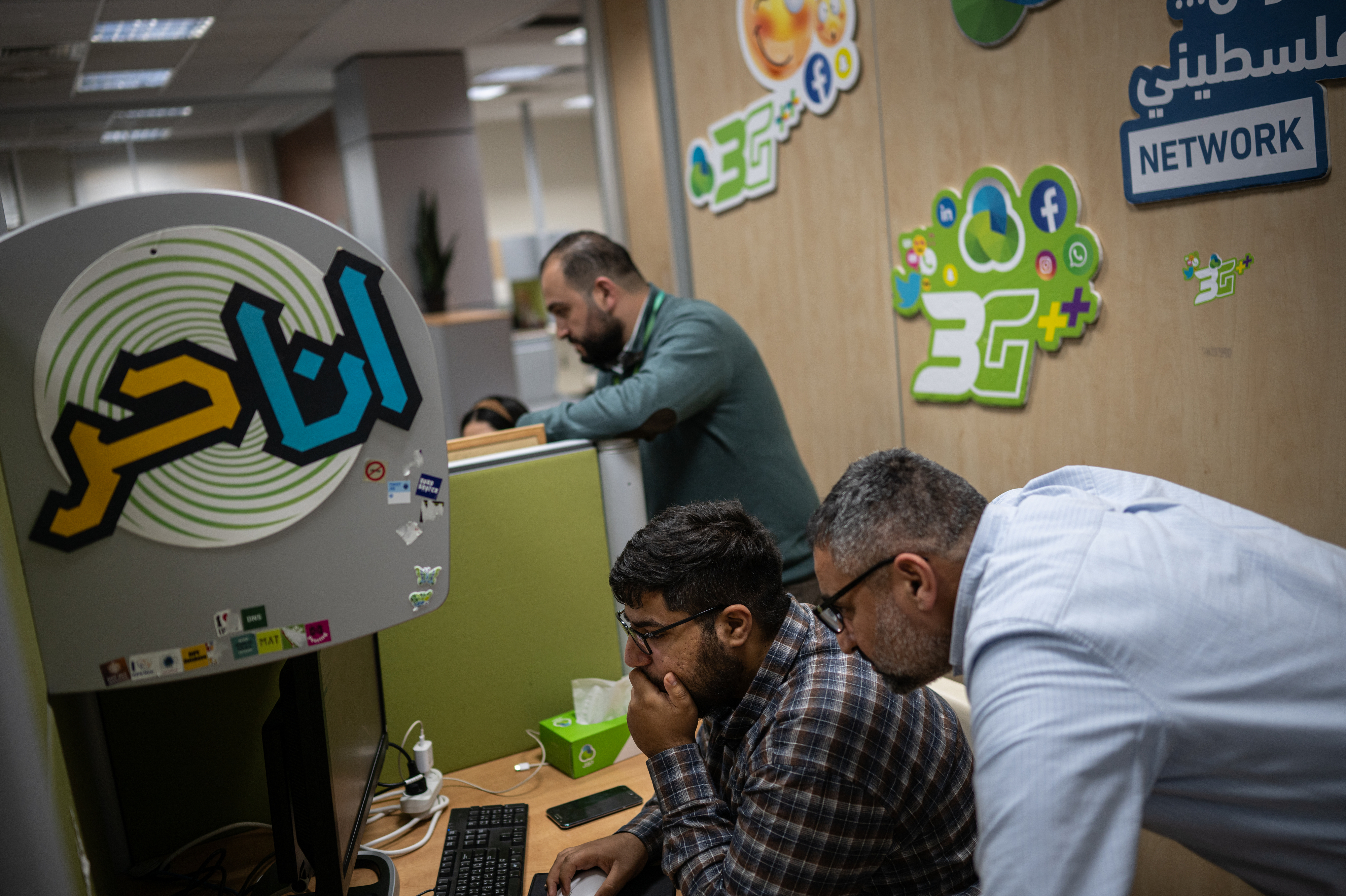 Employees work at the Paltel headquarters in Ramallah in the West Bank on Jan. 31.