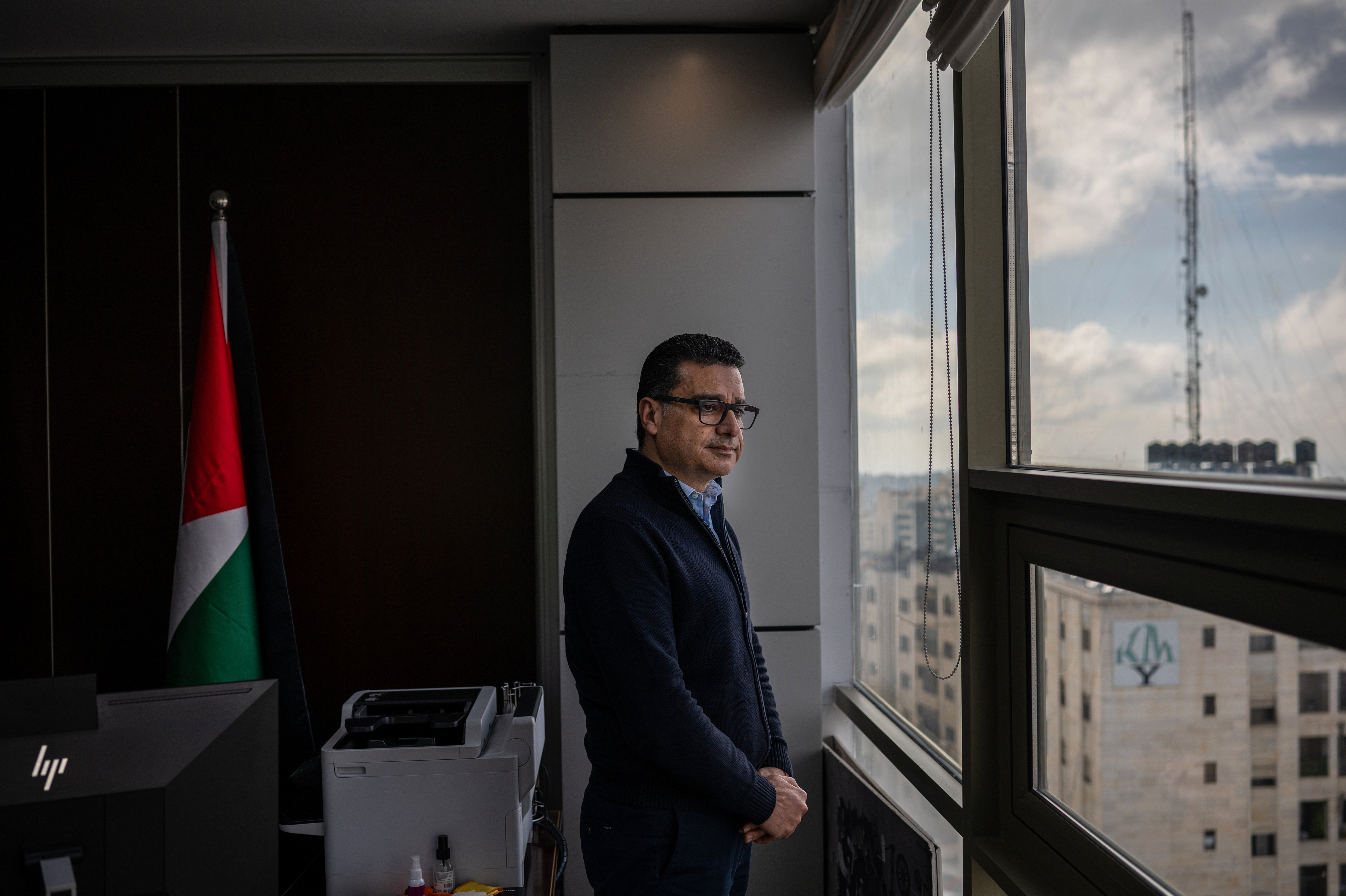 Mamoon Fares, corporate support director for Paltel, stands in his office in Ramallah. "Working in this part of the world is very difficult," he says.