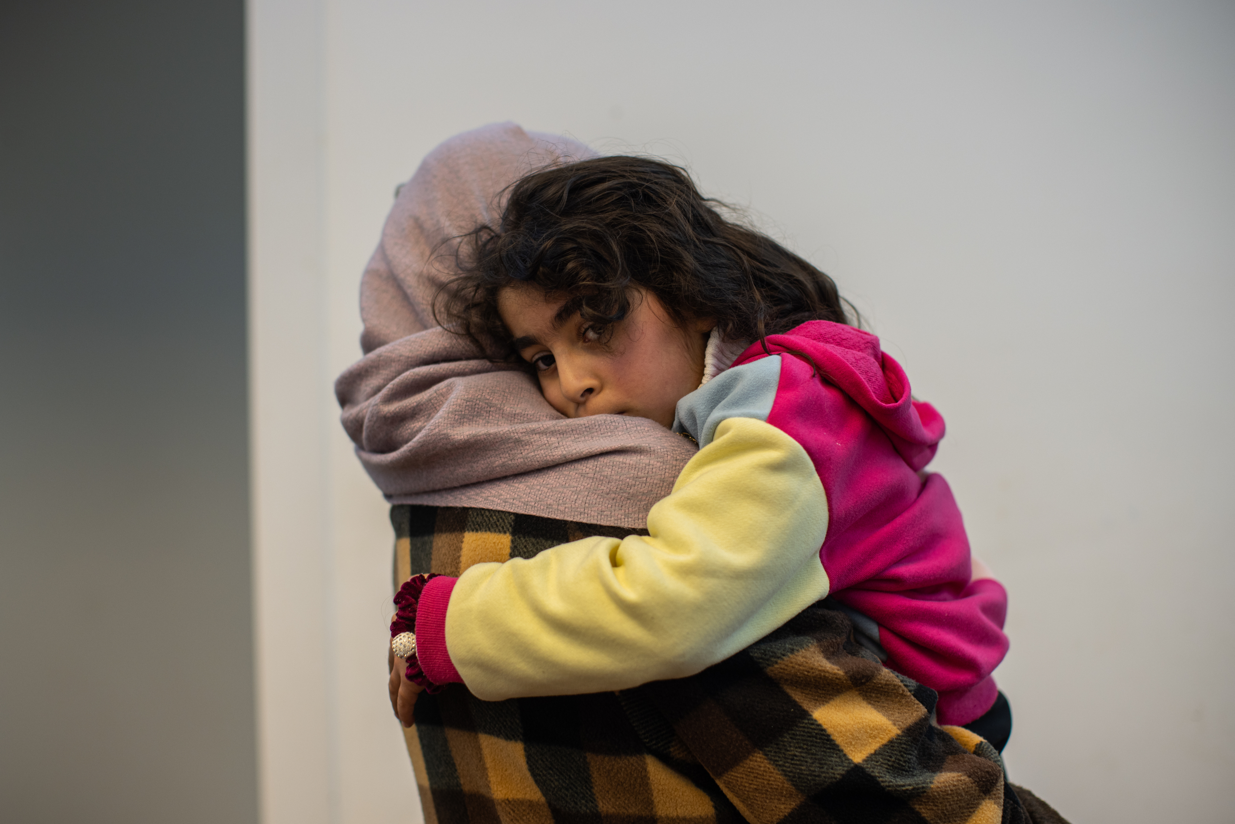 Rana holds her daughter Misk, 5, at their home in Ramallah.