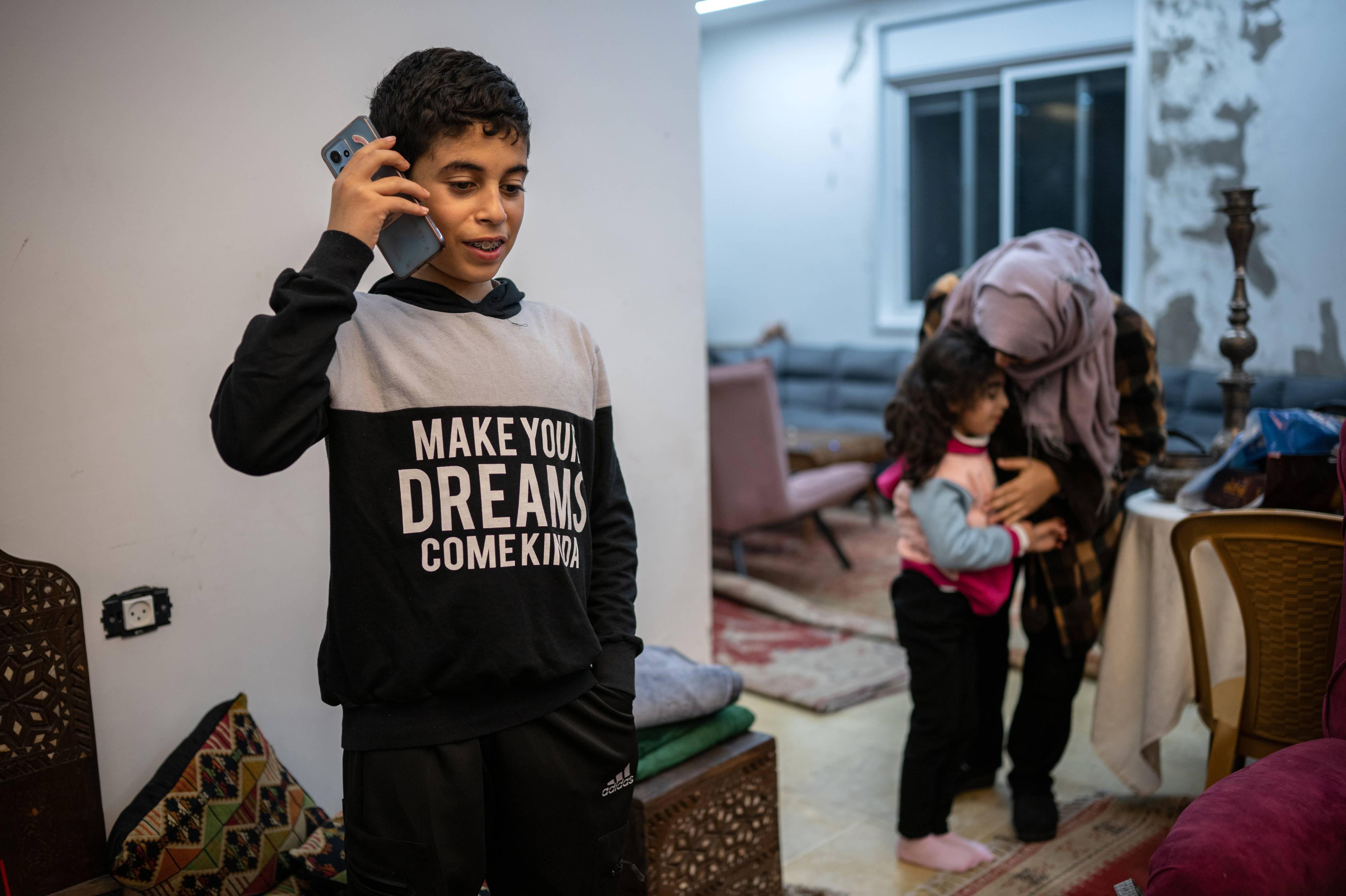 Ibrahim, 12, speaks to his grandmother, who lives in Gaza, from his home in Ramallah in the Israeli-occupied West Bank on Jan. 31. The family did not want to use their full names out of fear of reprisals from Israeli authorities. (Tamir Kalifa for NPR)