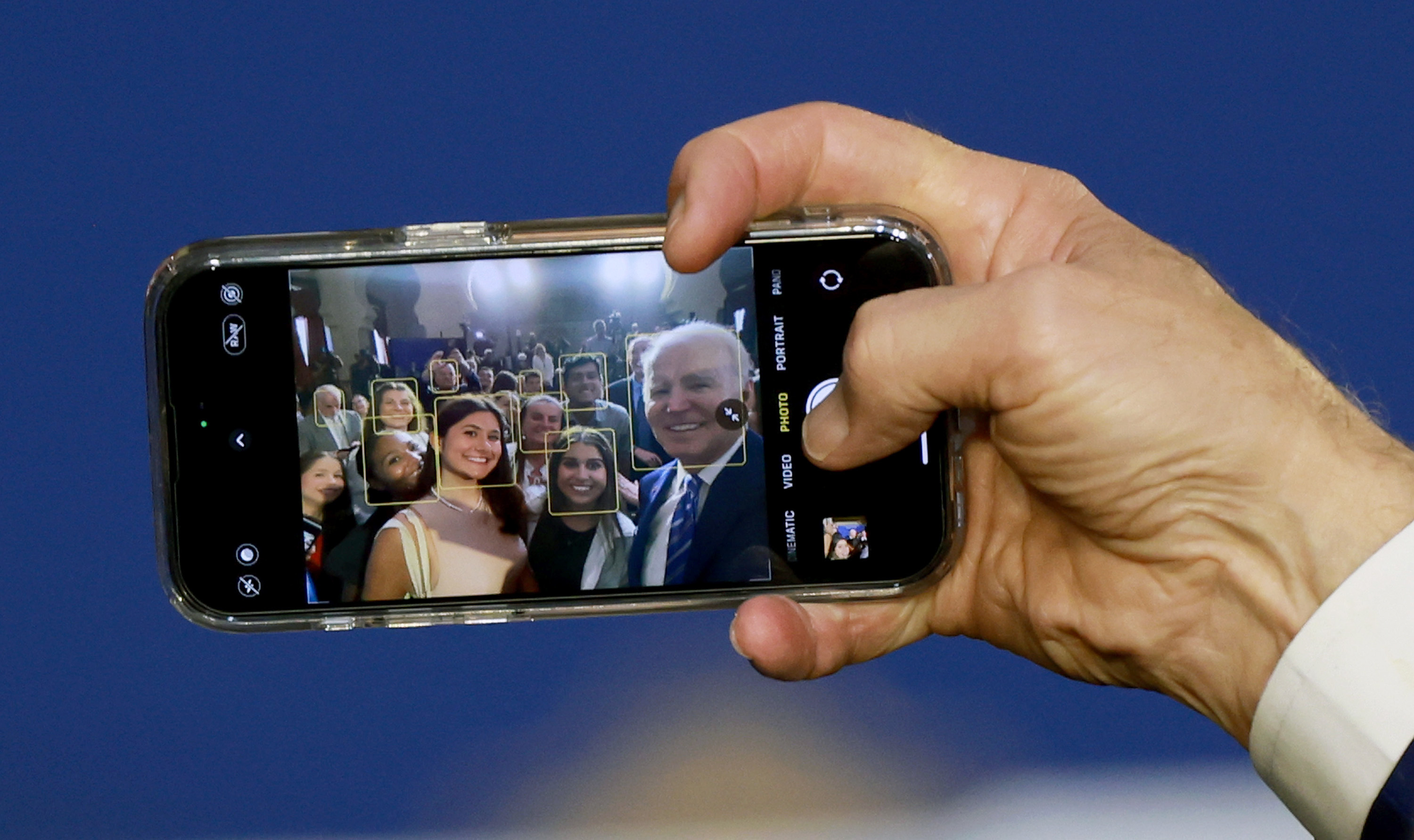 President Biden takes a selfie using a guest's phone during an event at the University of Tampa on Feb. 9, 2023. (Getty Images)
