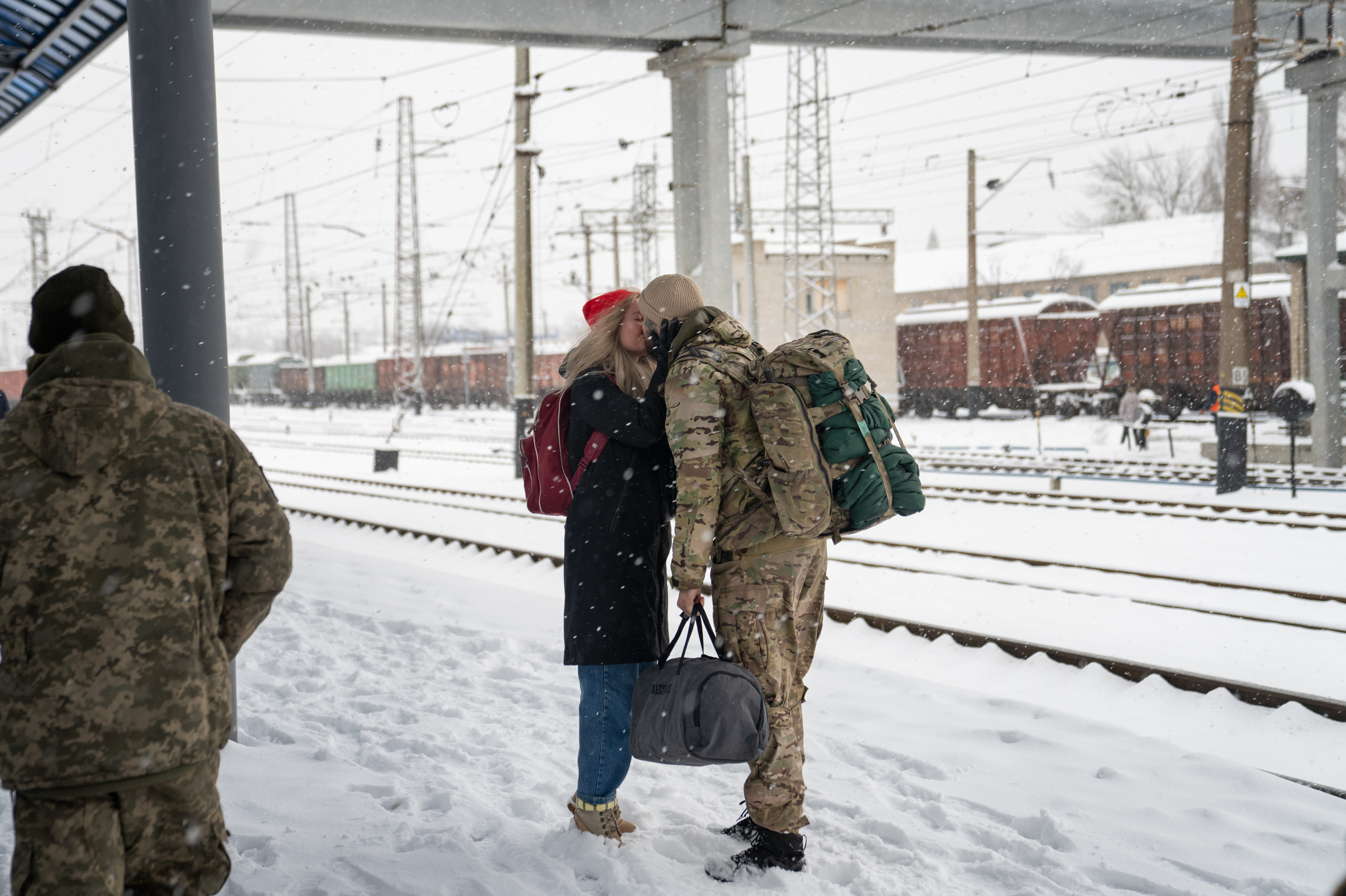 A soldier meets his partner at the train station in Sloviansk, in eastern Ukraine, ahead of Valentine's Day. (NPR)