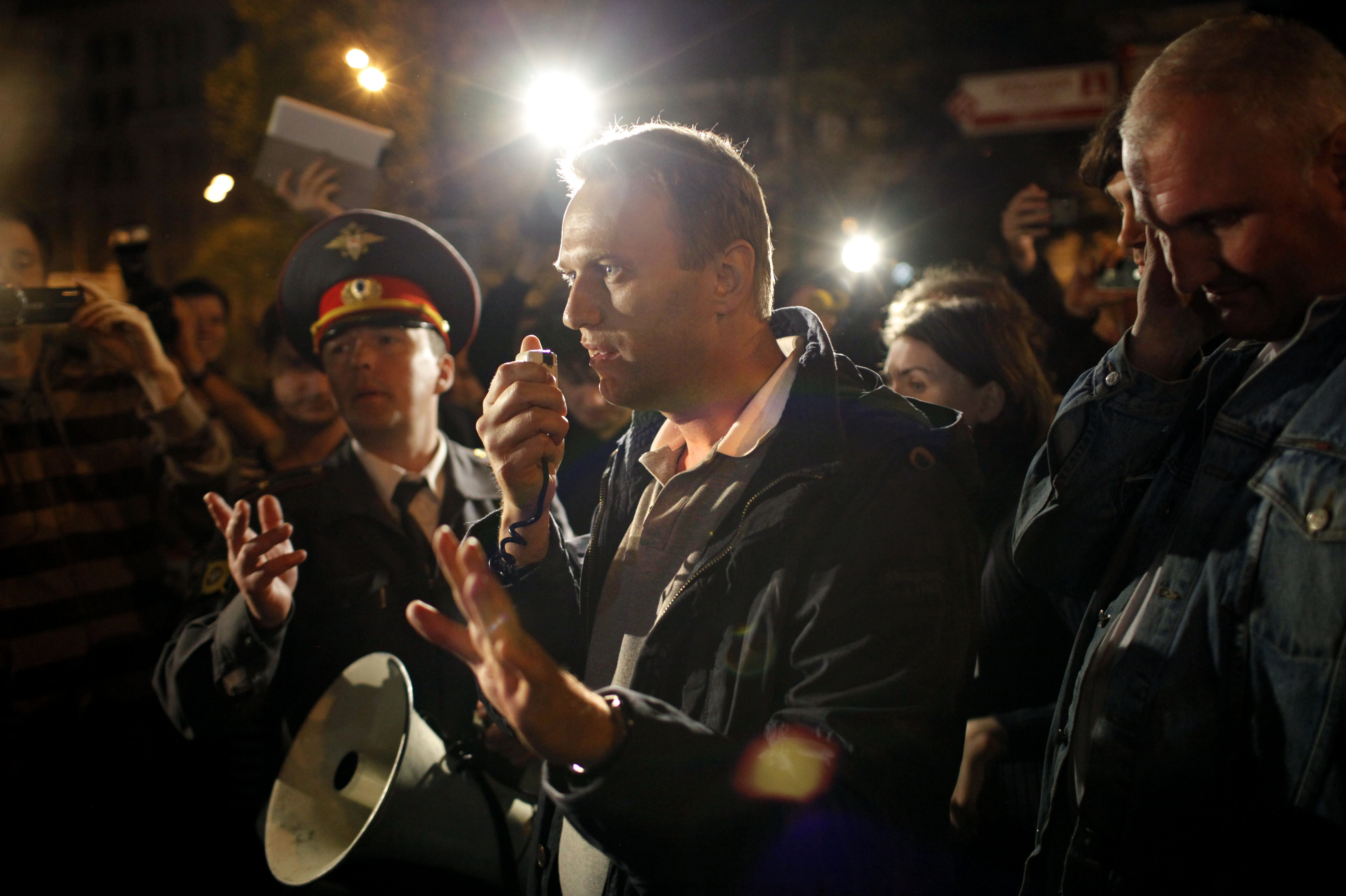 Photos: See Russian anti-corruption leader Alexei Navalny's life in pictures 2 May 8, 2012: Alexei Navalny, a prominent anti-corruption whistle blower and blogger, center, speaks to protesters gathered across the street from the presidential administrations building as a police officer tries to stop him in downtown Moscow.