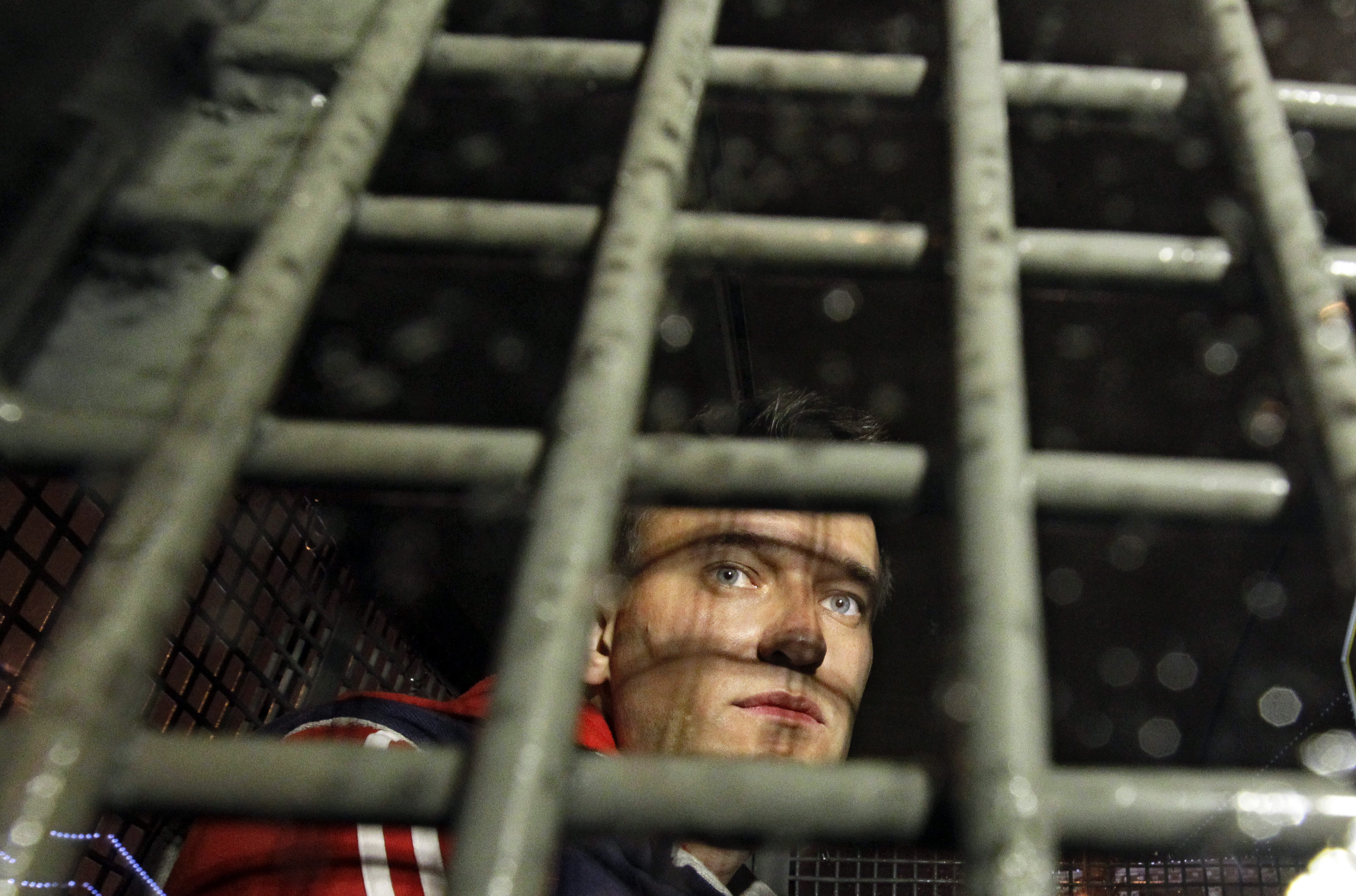 Photos: See Russian anti-corruption leader Alexei Navalny's life in pictures 3 May 8, 2012: Alexei Navalny is seen behind the bars in the police van after he was detained during protests in Moscow, on a day after Putin's inauguration.