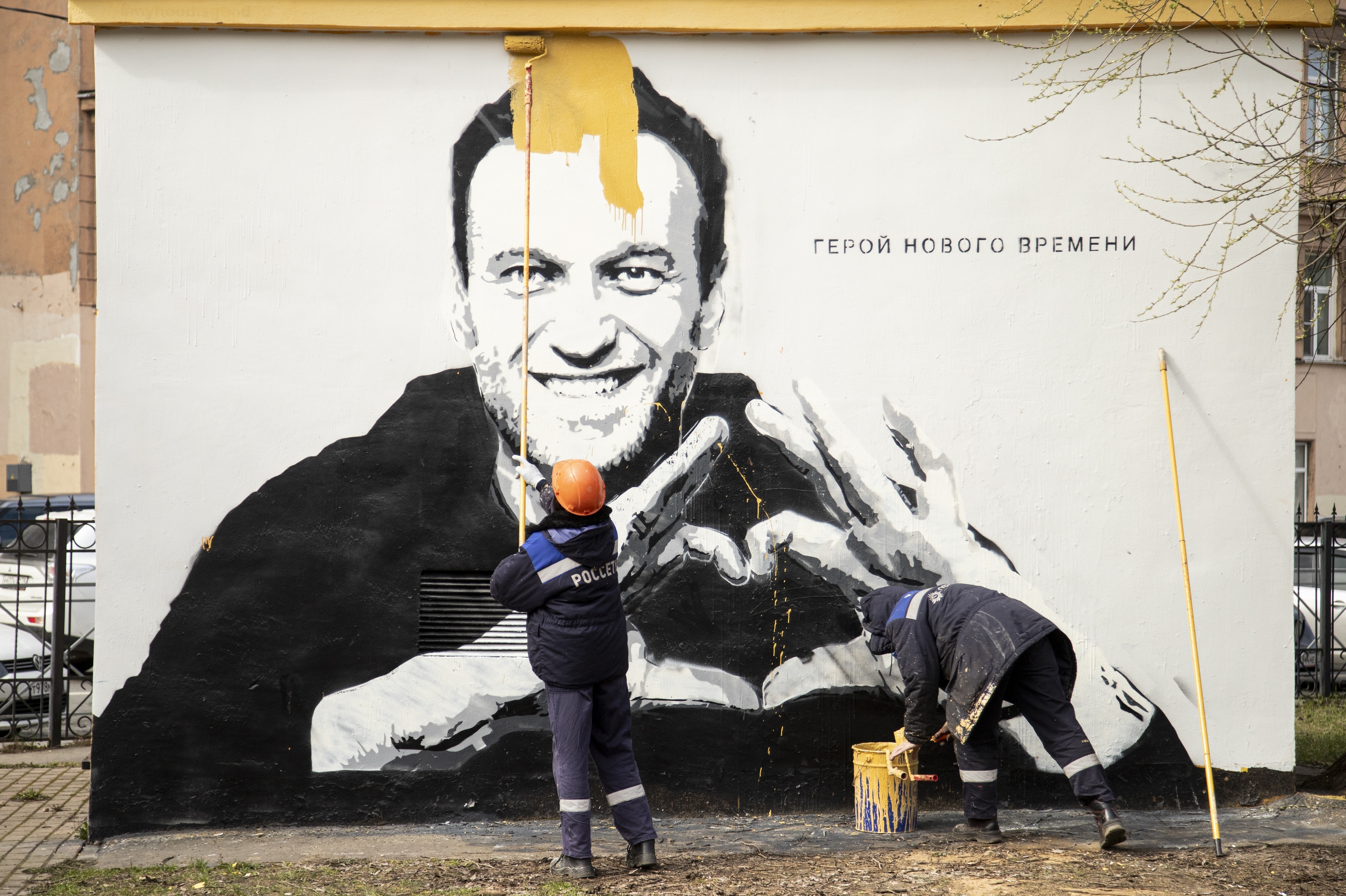 Photos: See Russian anti-corruption leader Alexei Navalny's life in pictures 15 April 28, 2021: Municipal workers paint over graffiti of Russia's imprisoned opposition leader Alexei Navalny in St. Petersburg, Russia . The words on the wall reading "Hero of a New Time".