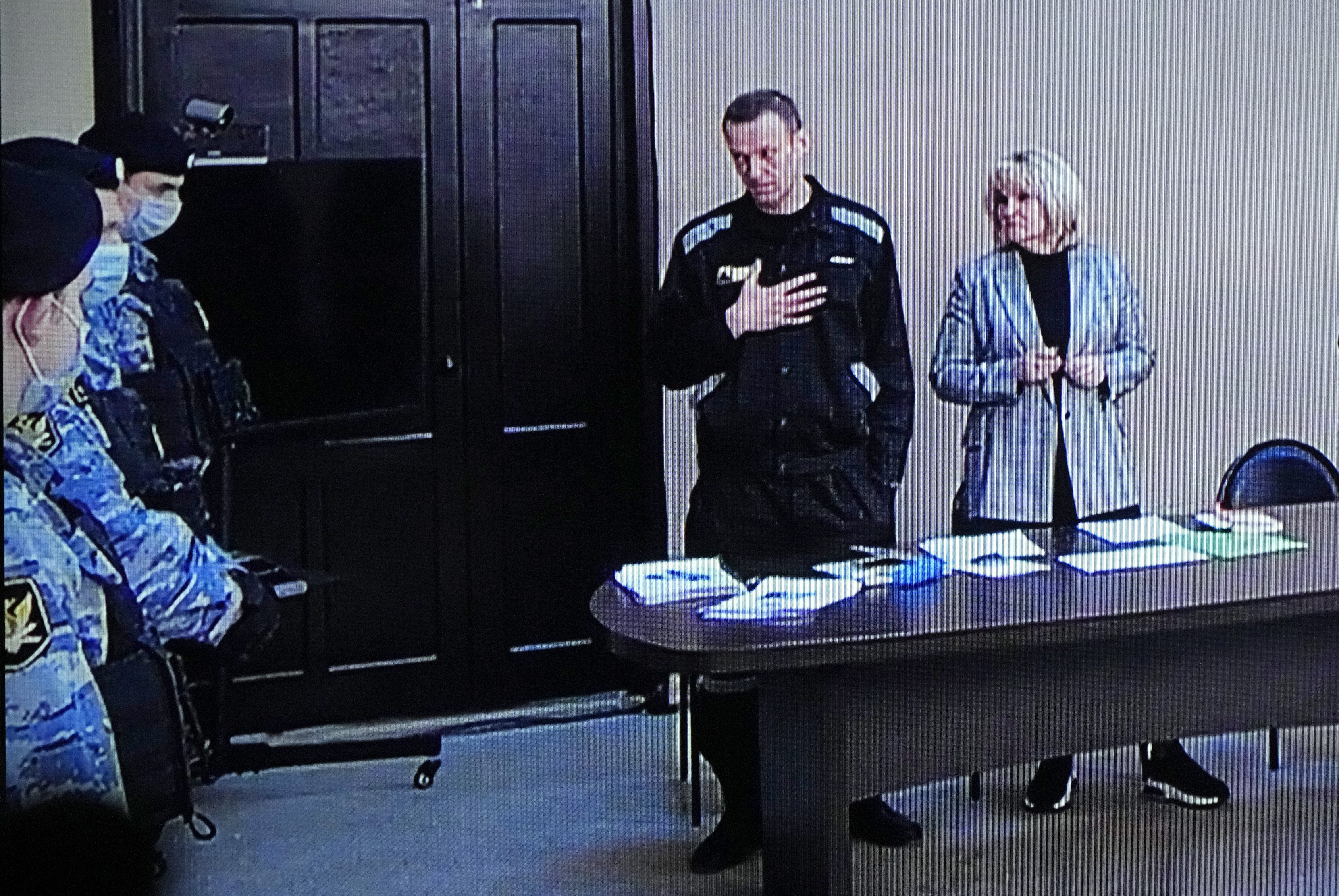 Photos: See Russian anti-corruption leader Alexei Navalny's life in pictures 16 March 22, 2022: Russian opposition leader Alexei Navalny, centre, gestures via a video link provided by the Russian Federal Penitentiary Service, standing next to his lawyer and speaking with Penitentiary Service officers during a court session, in Pokrov.