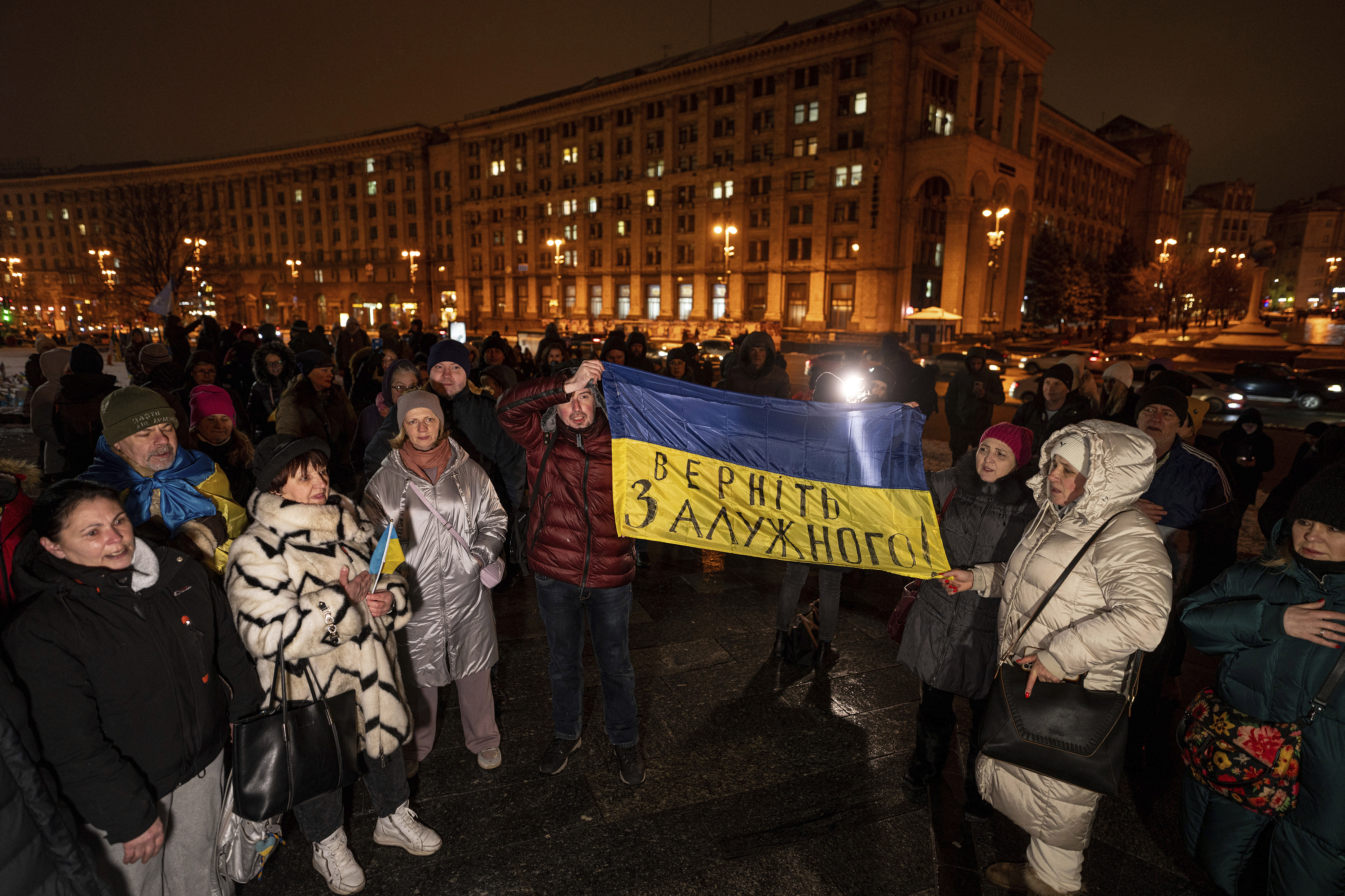 Demonstrators hold a Ukrainian flag during a protest a day after the resignation of Gen. Valeriy Zaluzhnyi at Independence Square in Kyiv, Ukraine, on Feb. 9.