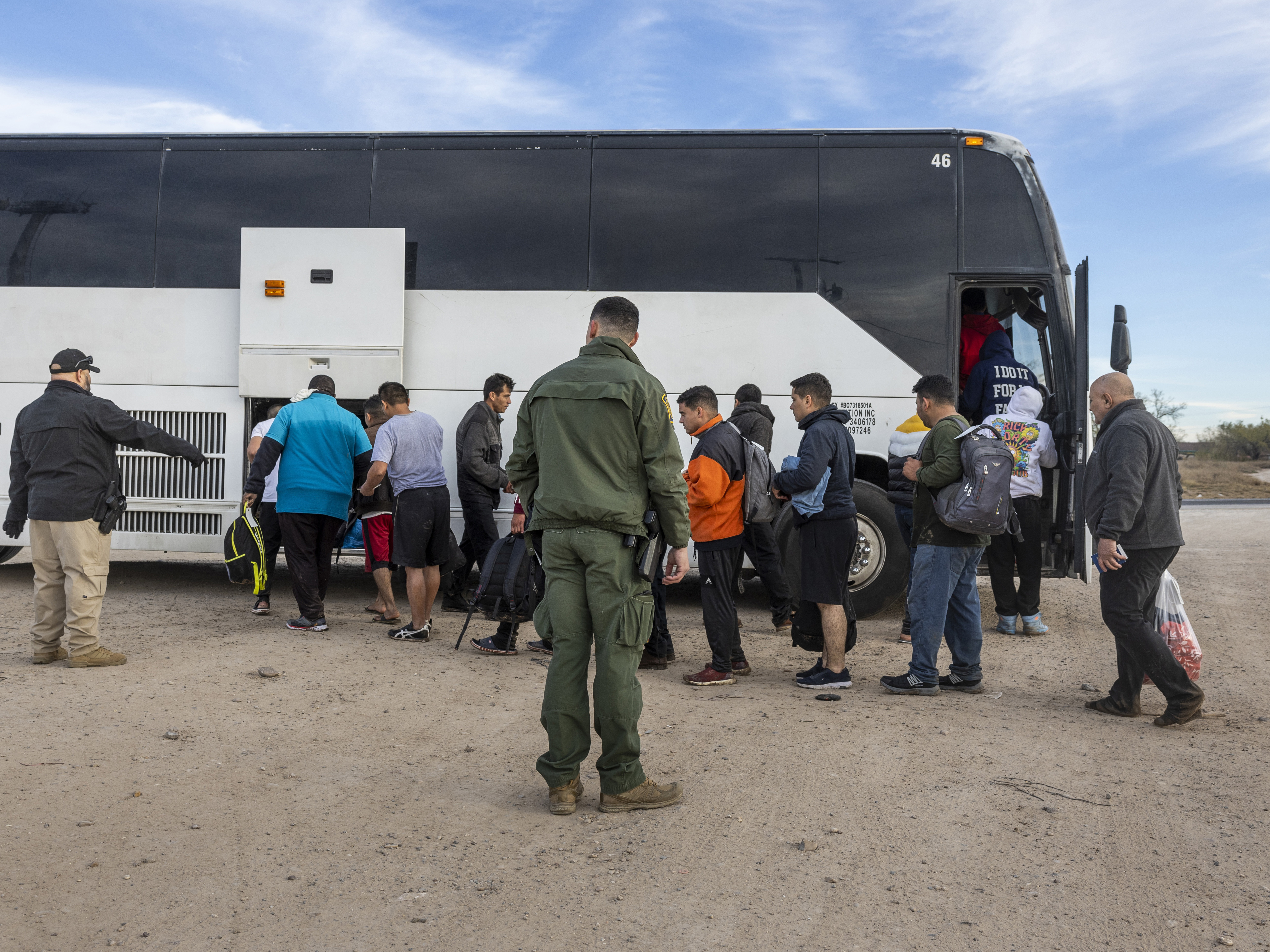 Immigrants file into a U.S. Customs and Border Protection bus after crossing the U.S.-Mexico border on January 07, 2024 in Eagle Pass, Texas. (Getty Images)