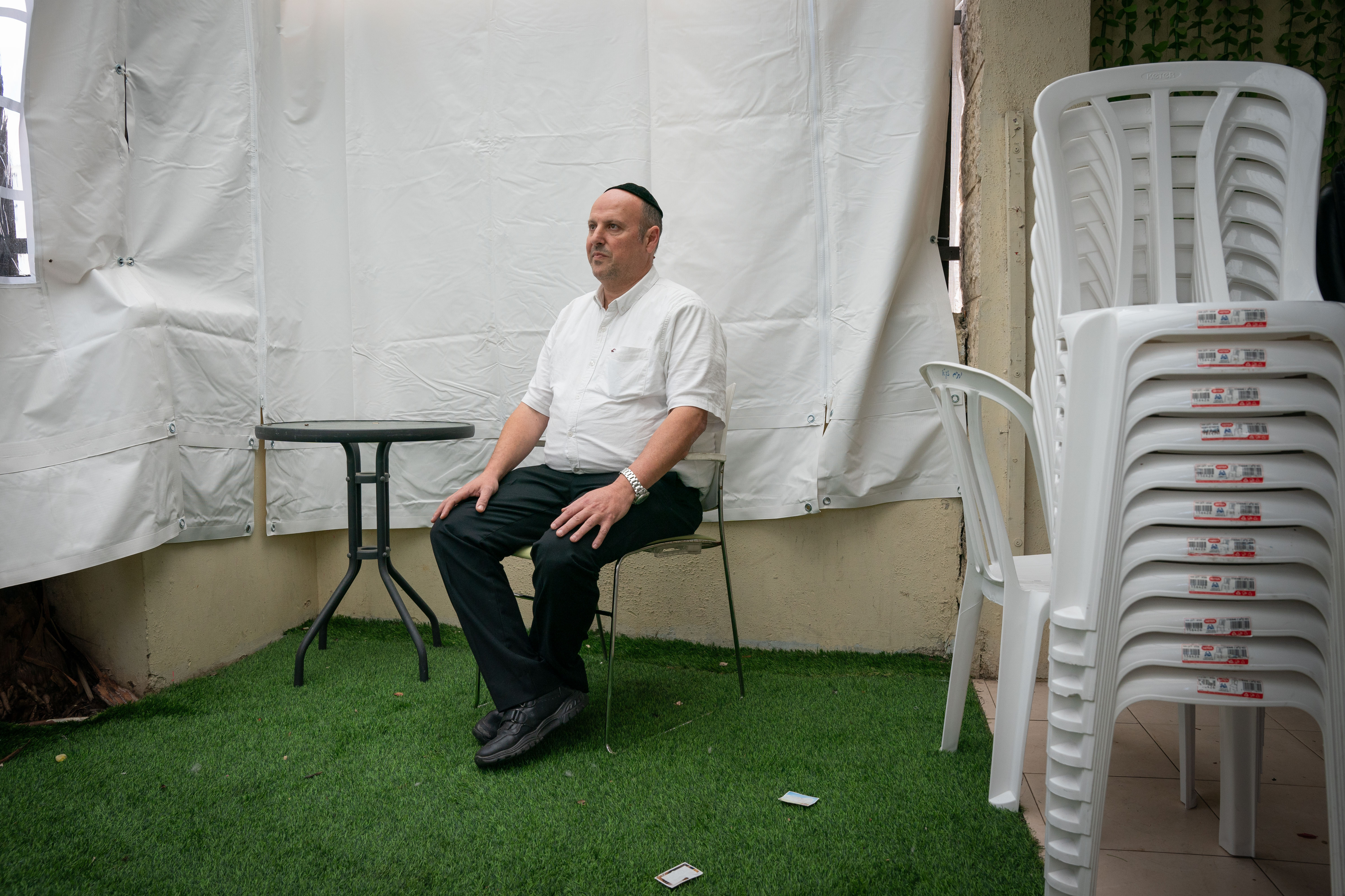 Chaim Otmazgin, 50, poses for a portrait in his home in Petah Tikva, Israel. (Maya Levin for NPR)