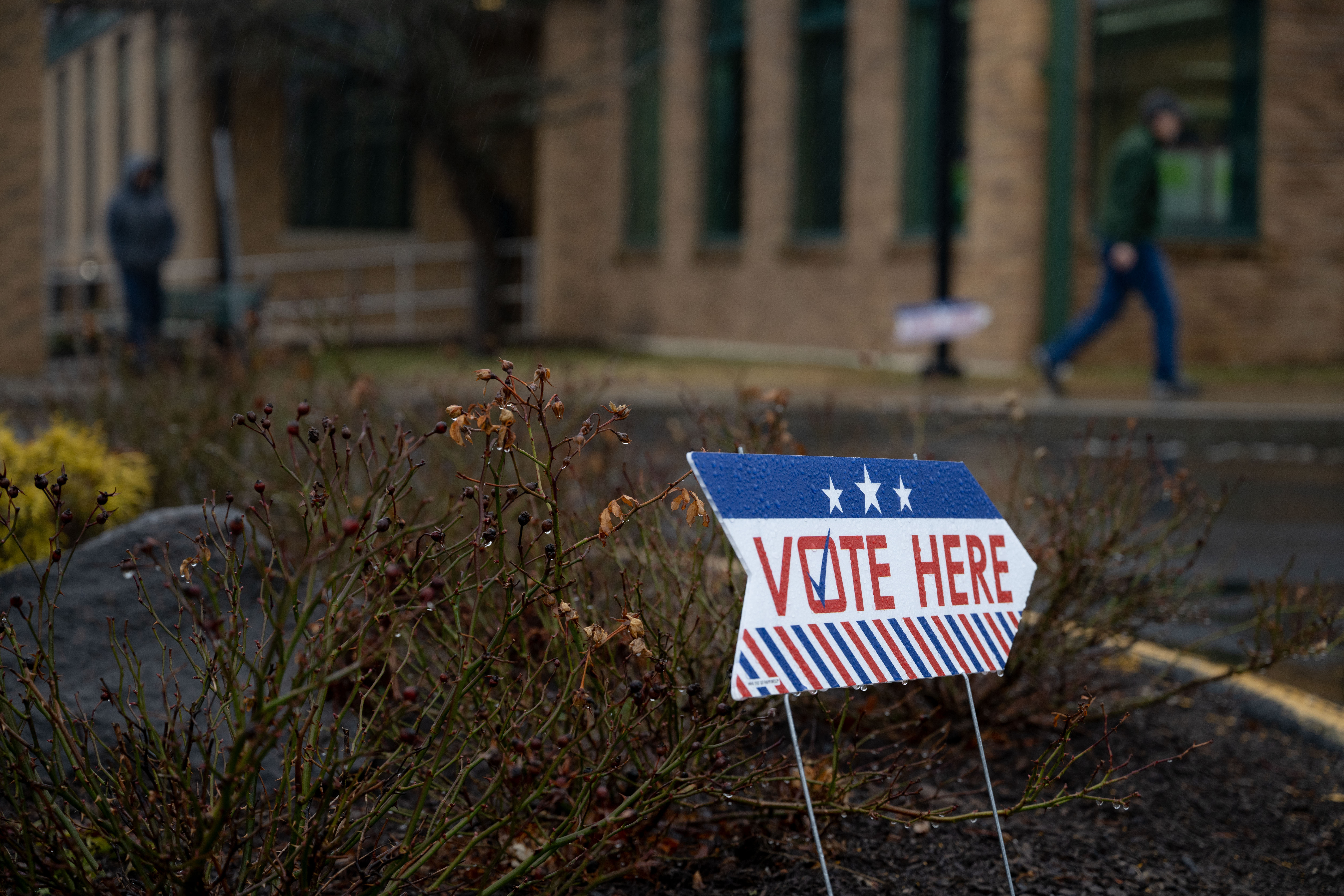 People walk outside of the Southwick Senior Center polling place in Southwick, Mass.