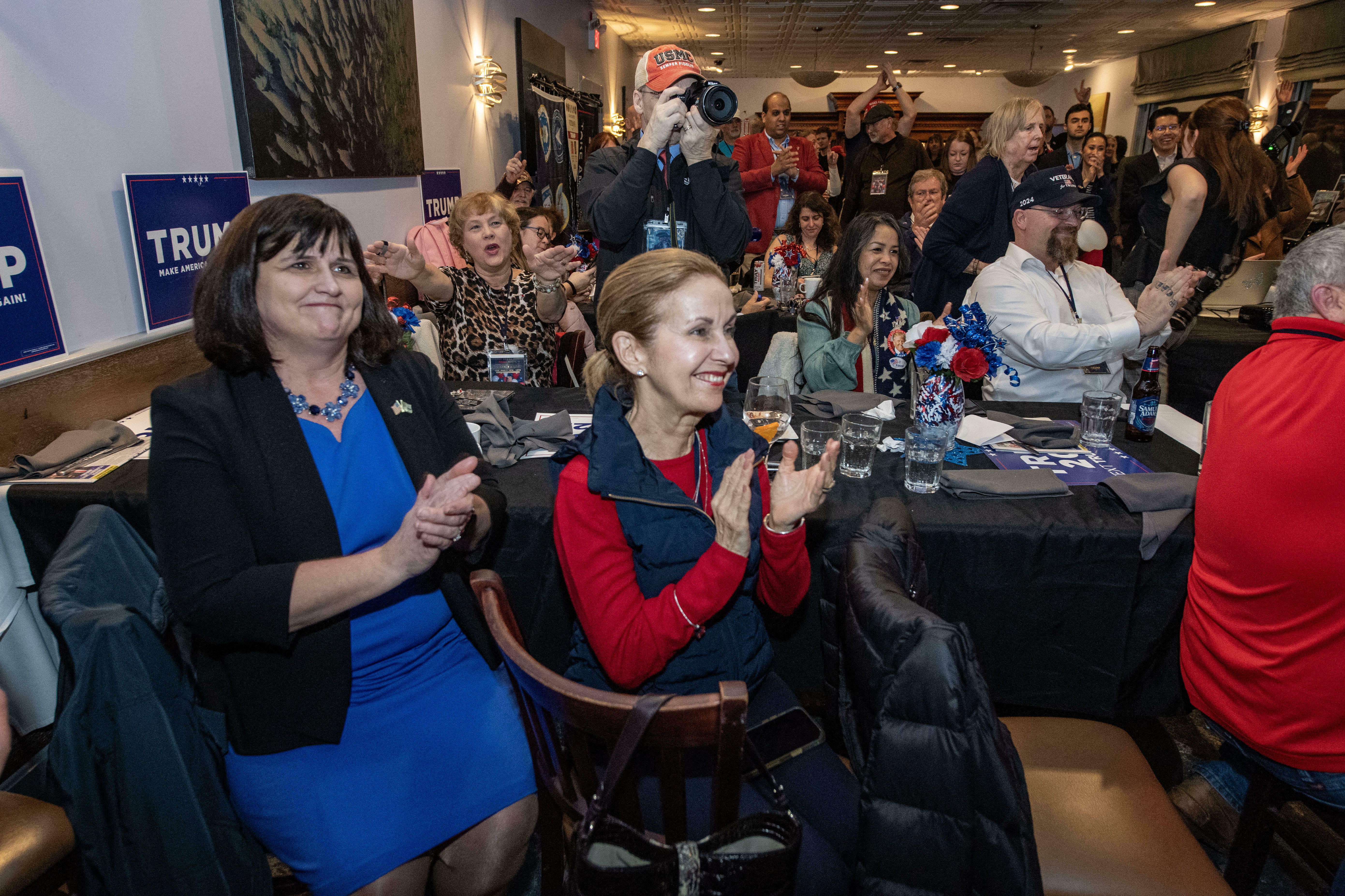 Supporters of former President Donald Trump cheer as he is declared the projected winner in Massachusetts during a "Victory Party" for the "Super Tuesday" election primaries in Quincy, Mass.