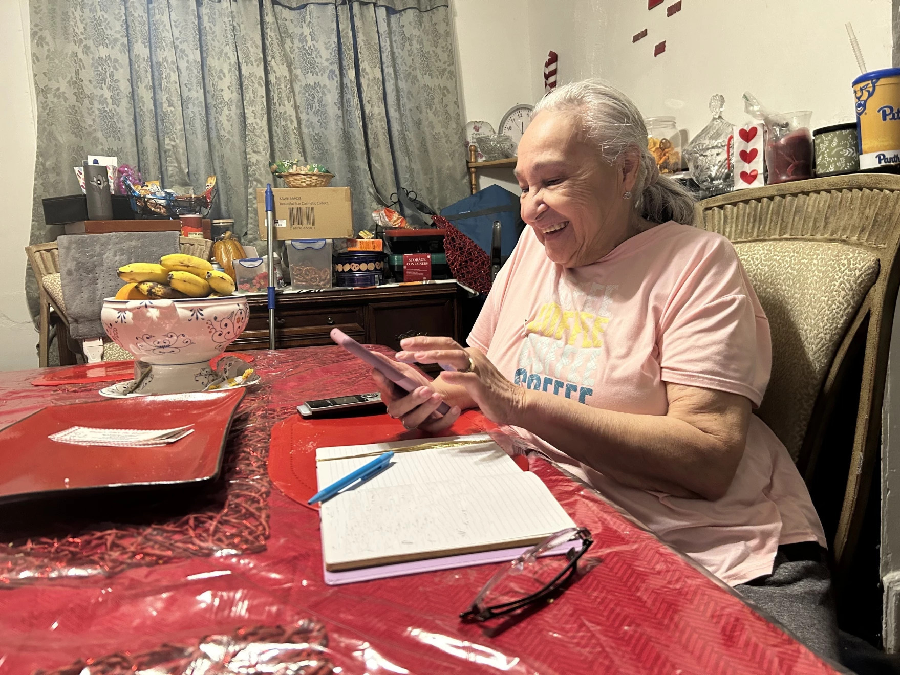 Kathryn Sellers makes calls to families on Wednesday, Feb. 14. Sellers is part of a program that provides students at Pittsburgh Arlington school with free van rides to and from school each day, as well as caring nanas who check in with families daily. (WESA)