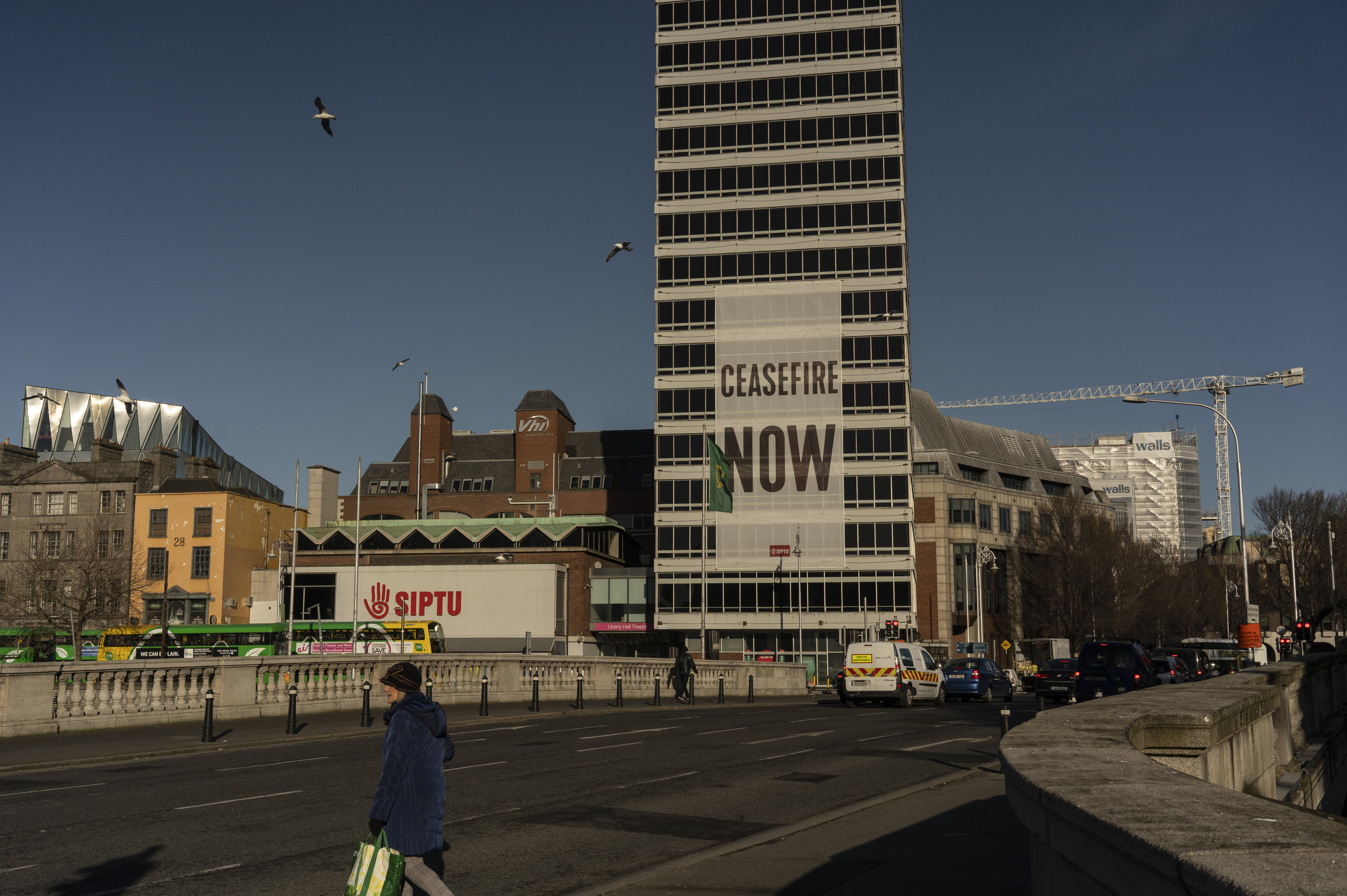 A large sign calling for a cease-fire in Gaza hangs from a building in Dublin on Feb. 12. (Paulo Nunes dos Santos for NPR)