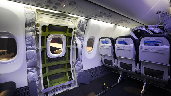 The inside of Boeing 737 Max 9 plane, with paneling removed from the door plug area.