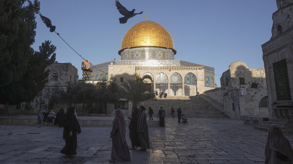 People walk next to the Dome of Rock Mosque at the Al-Aqsa Mosque in Jerusalem's Old City.