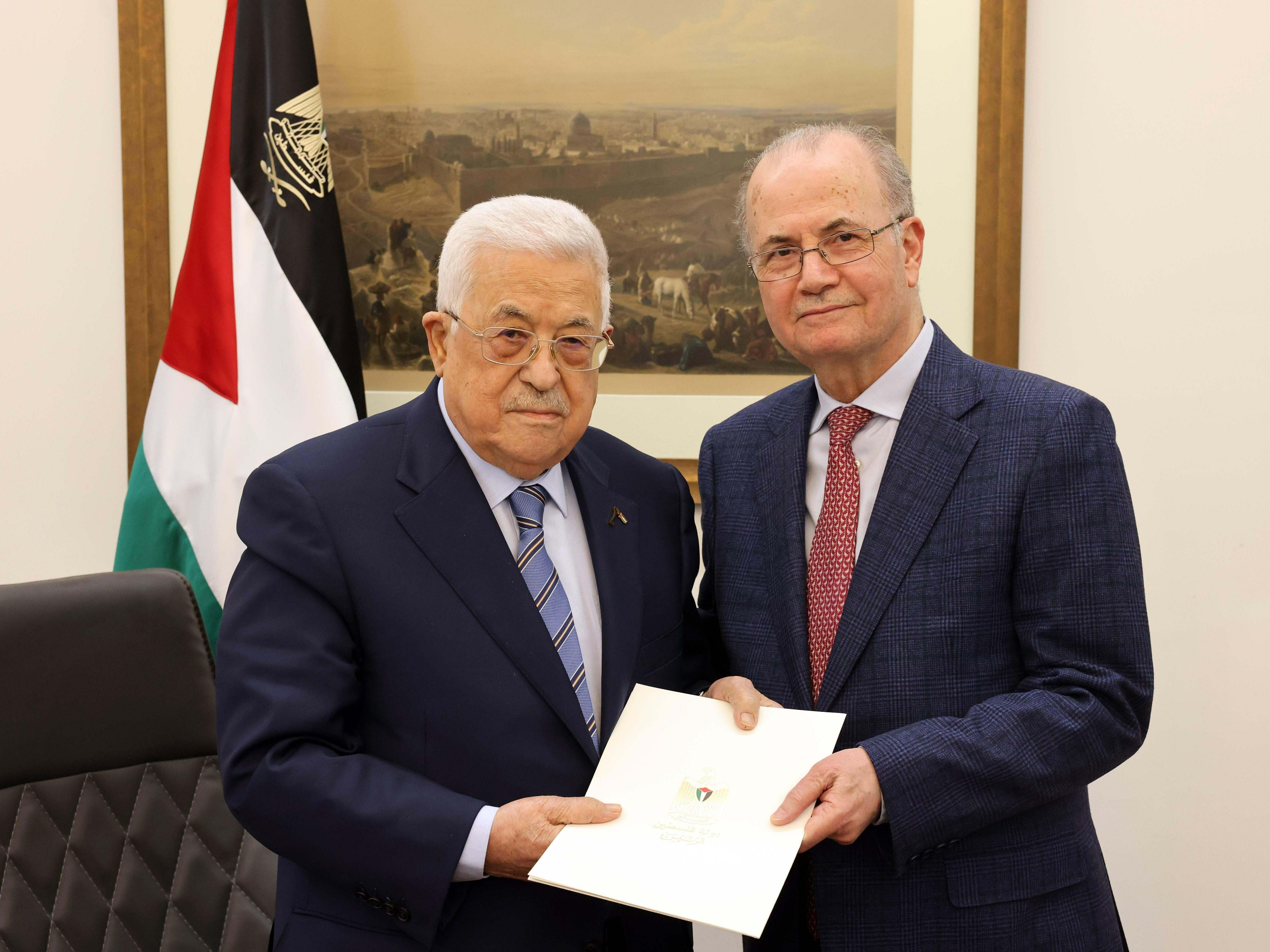 Palestinian President Mahmoud Abbas (left) poses with Mohammad Mustafa, the former deputy prime minister and the chairman of the Palestine Investment Fund, after the latter was appointed as new prime minister of the Palestinian Authority, in Ramallah, West Bank, on Thursday. (Palestinian Presidency/Anadolu via Getty Images)