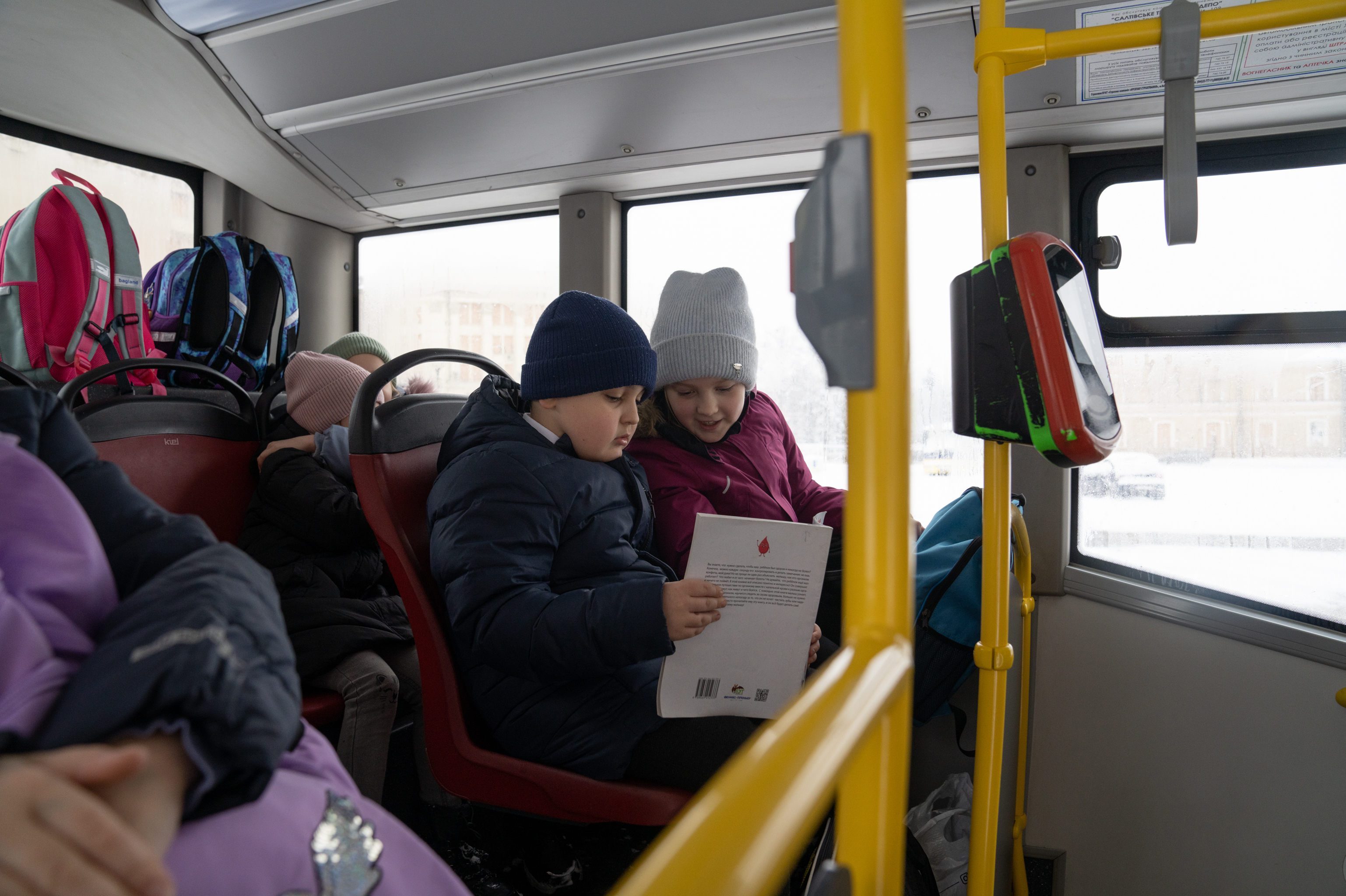 Ukraine's Kharkiv moves classrooms underground so kids survive Russian attacks 10 Maksym and his best friend, Kseniia, read a book on the bus while they head home from school.