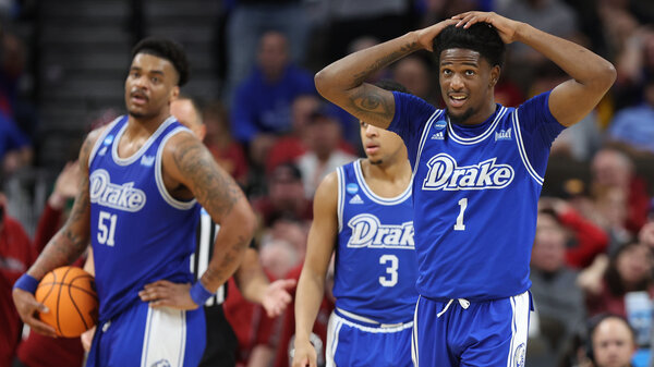 Three Drake men's basketball team players. 