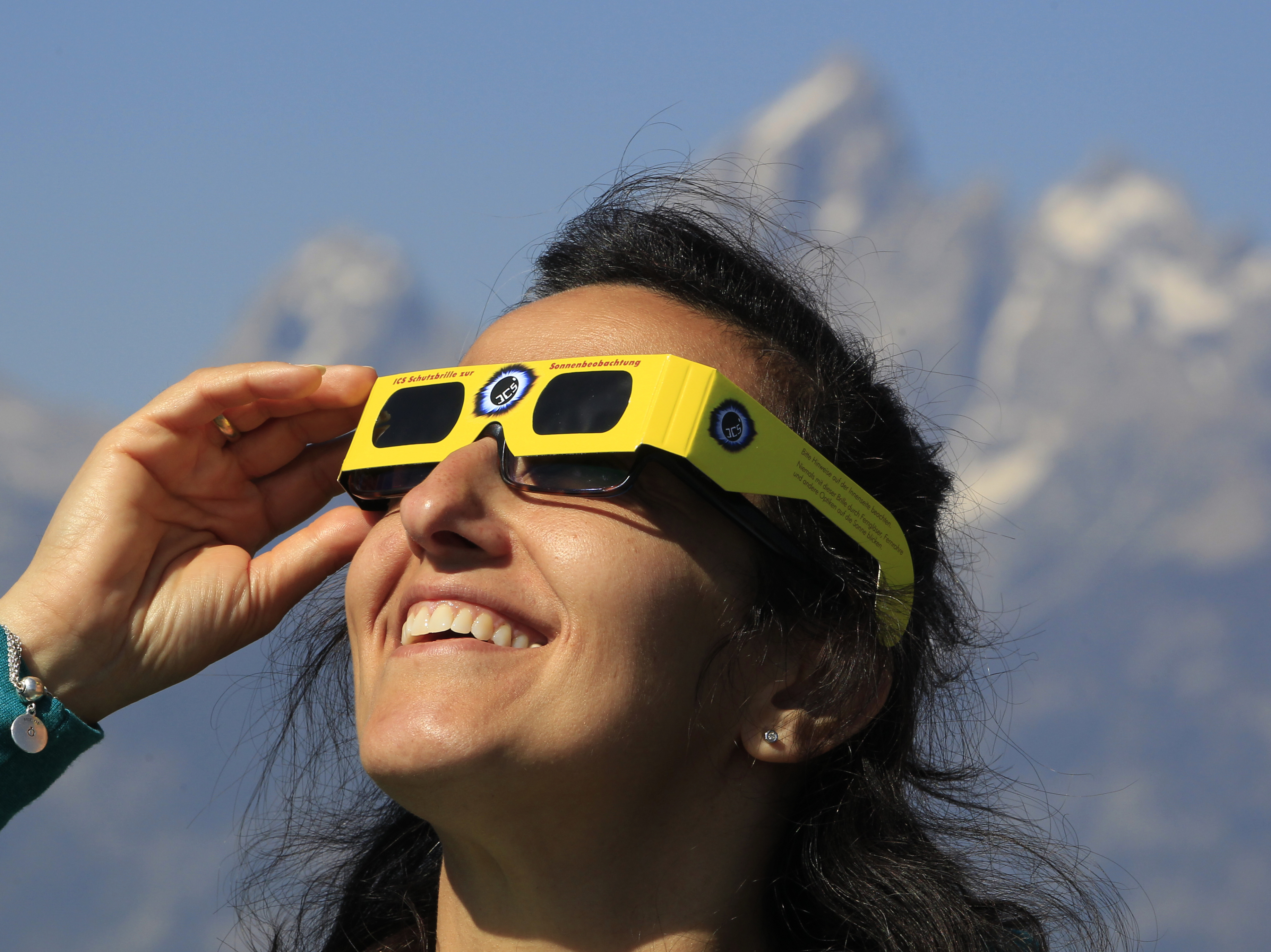 A woman views the solar eclipse in the first phase of a total eclipse in Grand Teton National Park on August 21, 2017 outside Jackson, Wyoming. (Getty Images)