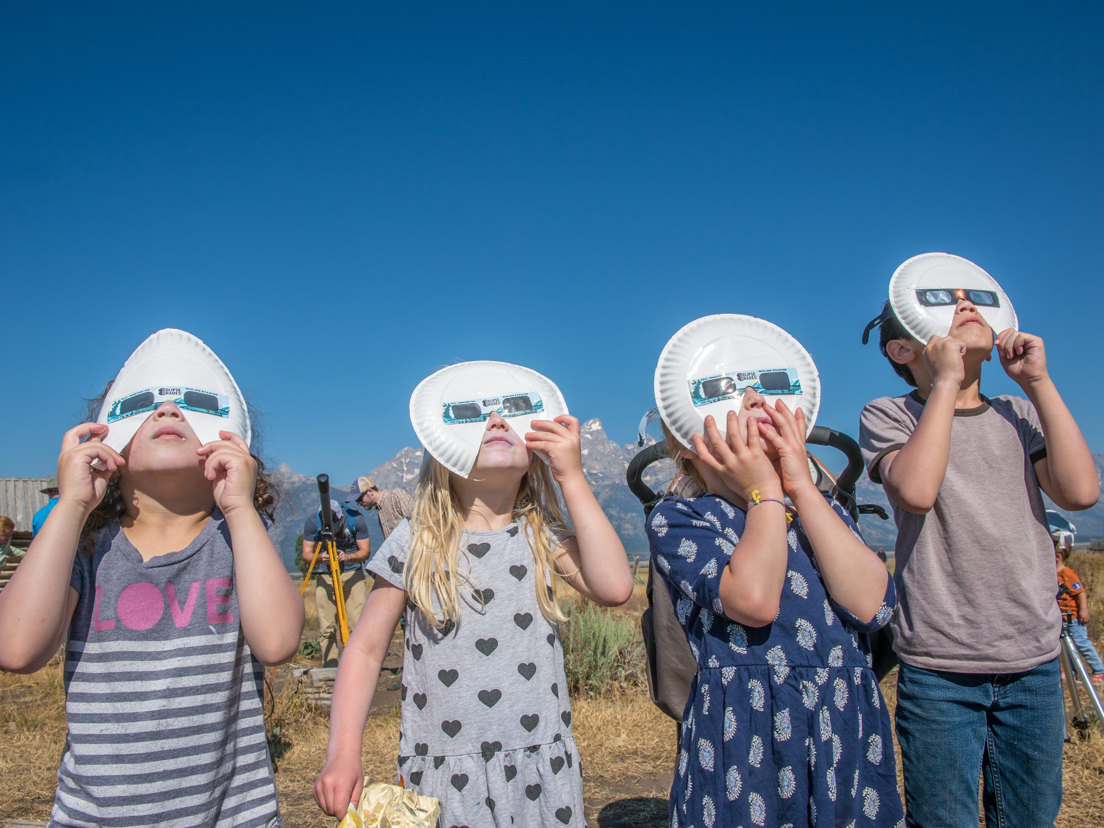 A group of children don eclipse glasses to watch the 2017 solar eclipse at Grand Tetons National Park in Wyoming. (Universal Images Group via Getty Images)