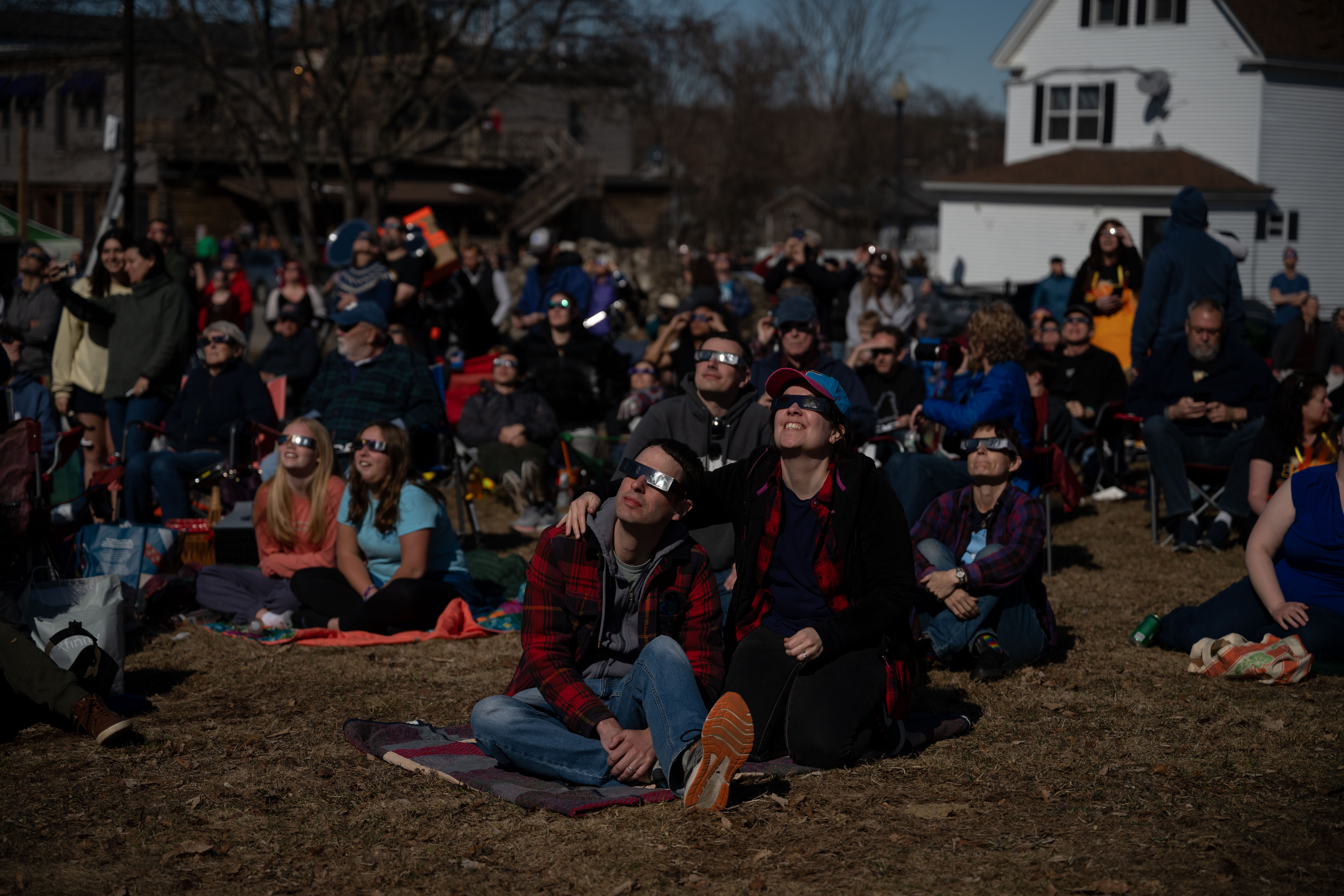 People watch as the total solar eclipse begins in Millinocket, Maine, on Monday.